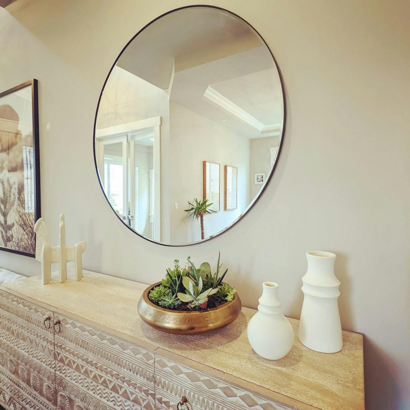 A vintage console combines geometric patterns with floral motifs to create an intriguing presence in this Entry Hallway designed by Persimmon Design