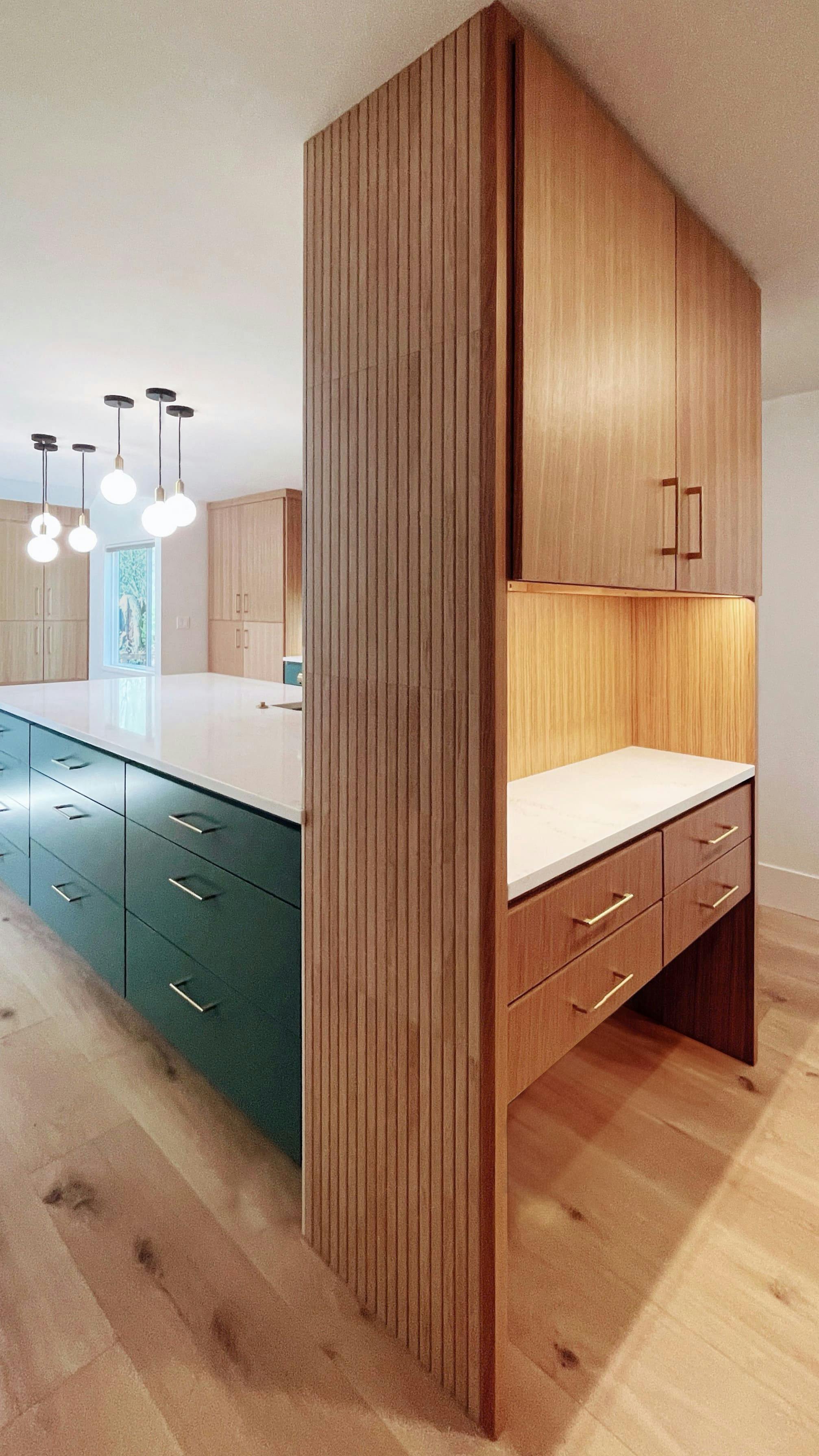 In this kitchen by Persimmon Design, a dedicated cat feeding station is included under a custom coffee bar.