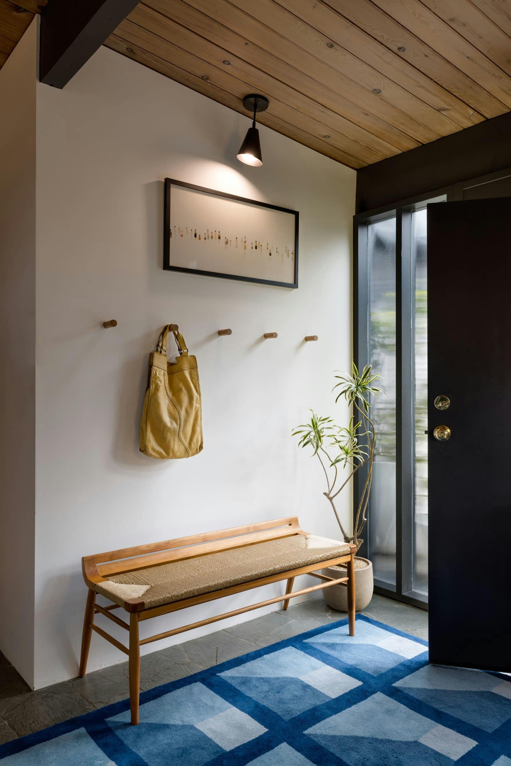 This entry foyer by Persimmon Design draws from the clients’ vibrant energy, layering color and texture in a way that feels at ease with the home’s mid-century bones.