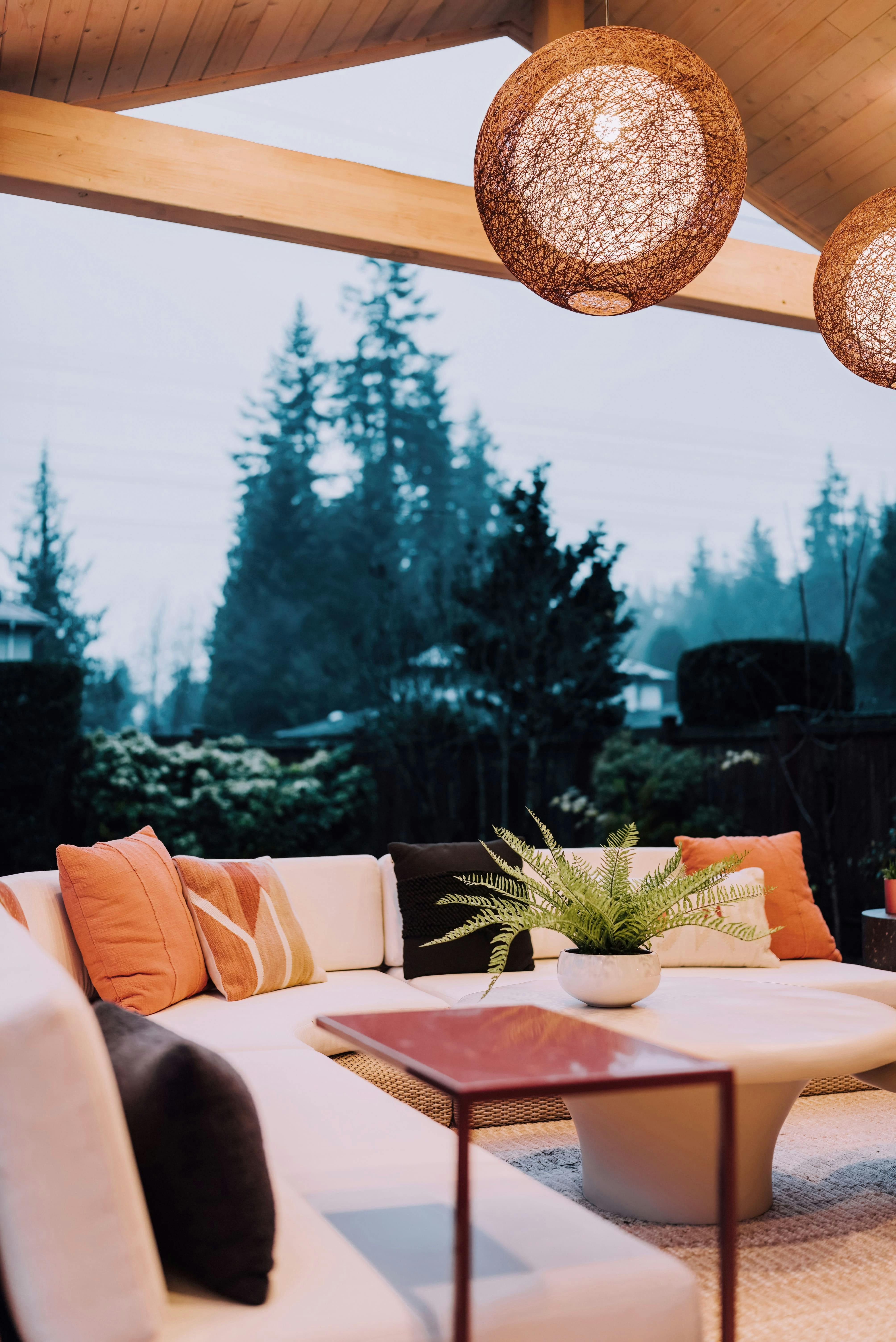 Huge orbs of light frame the evening sky and anchor this warm outdoor retreat by Persimmon Design