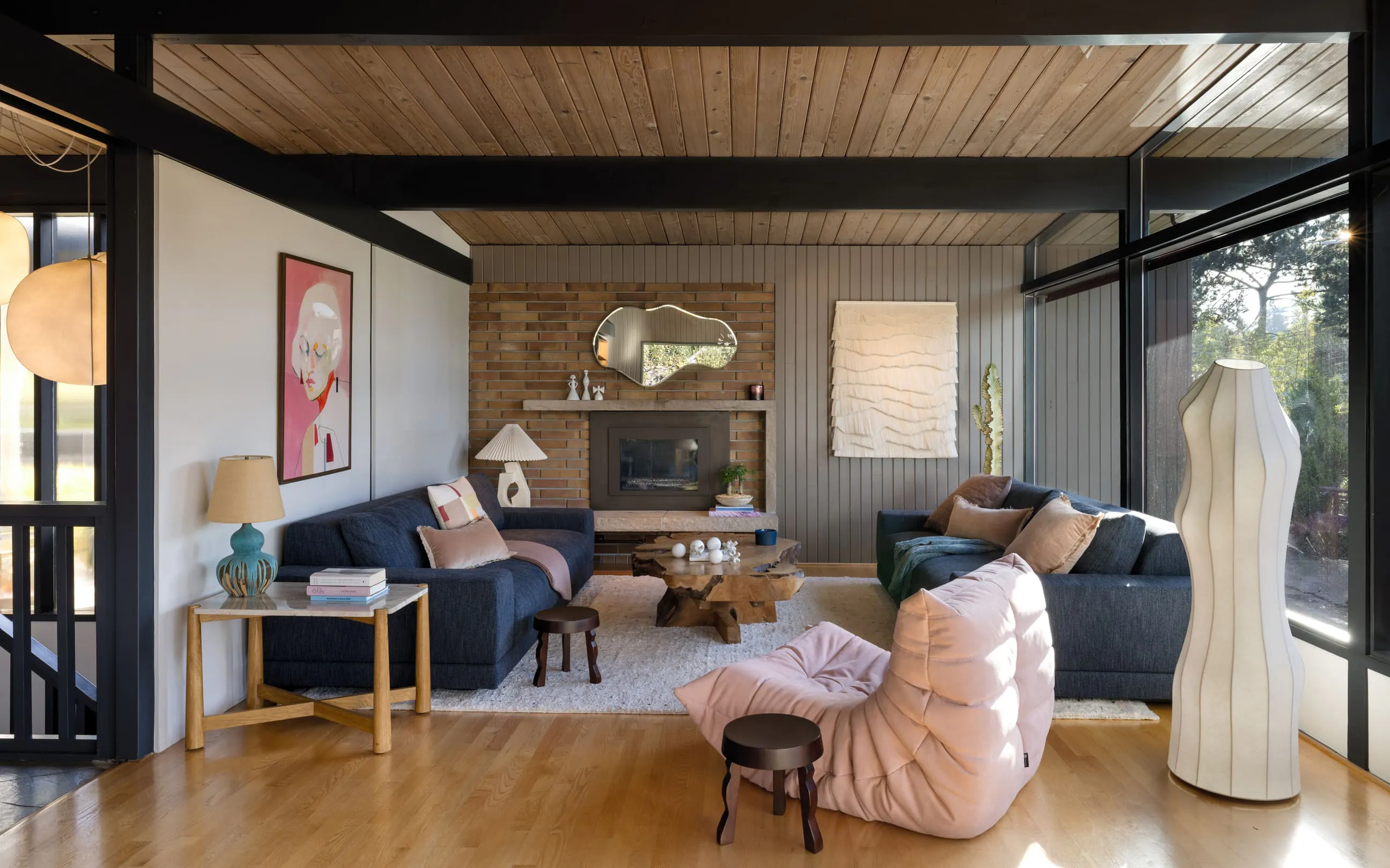 In this living room designed by Persimmon Design, wood beams were introduced to articulate the ceiling plane, adding warmth, rhythm, and architectural depth to what would otherwise have been a flat expanse.