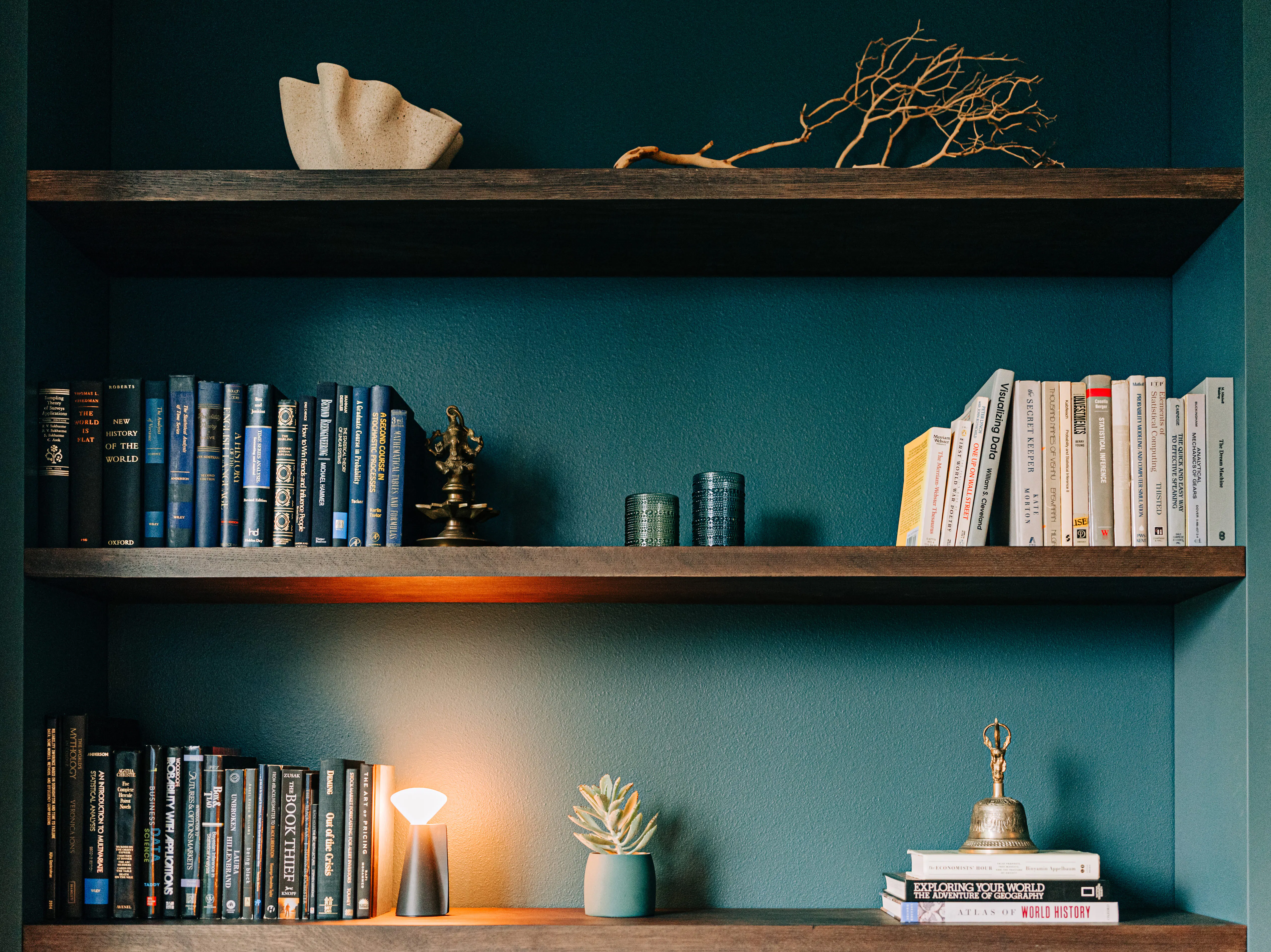 This home library designed by Persimmon Design showcases some of the client’s treasured objects collected from travels. Photo credit: Alexis Grosclaude