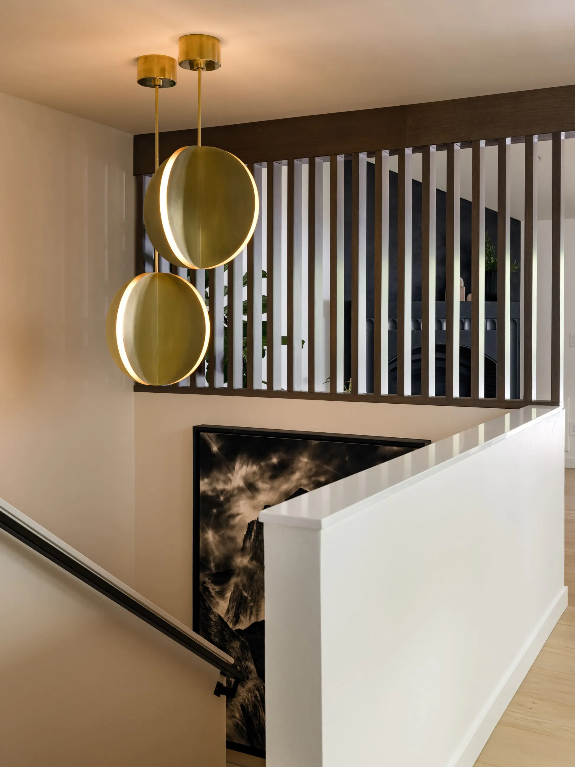A single sculptural gesture anchors this stairwell designed by Persimmon Design, establishing a clear focal point from which the rest of the composition unfolds.