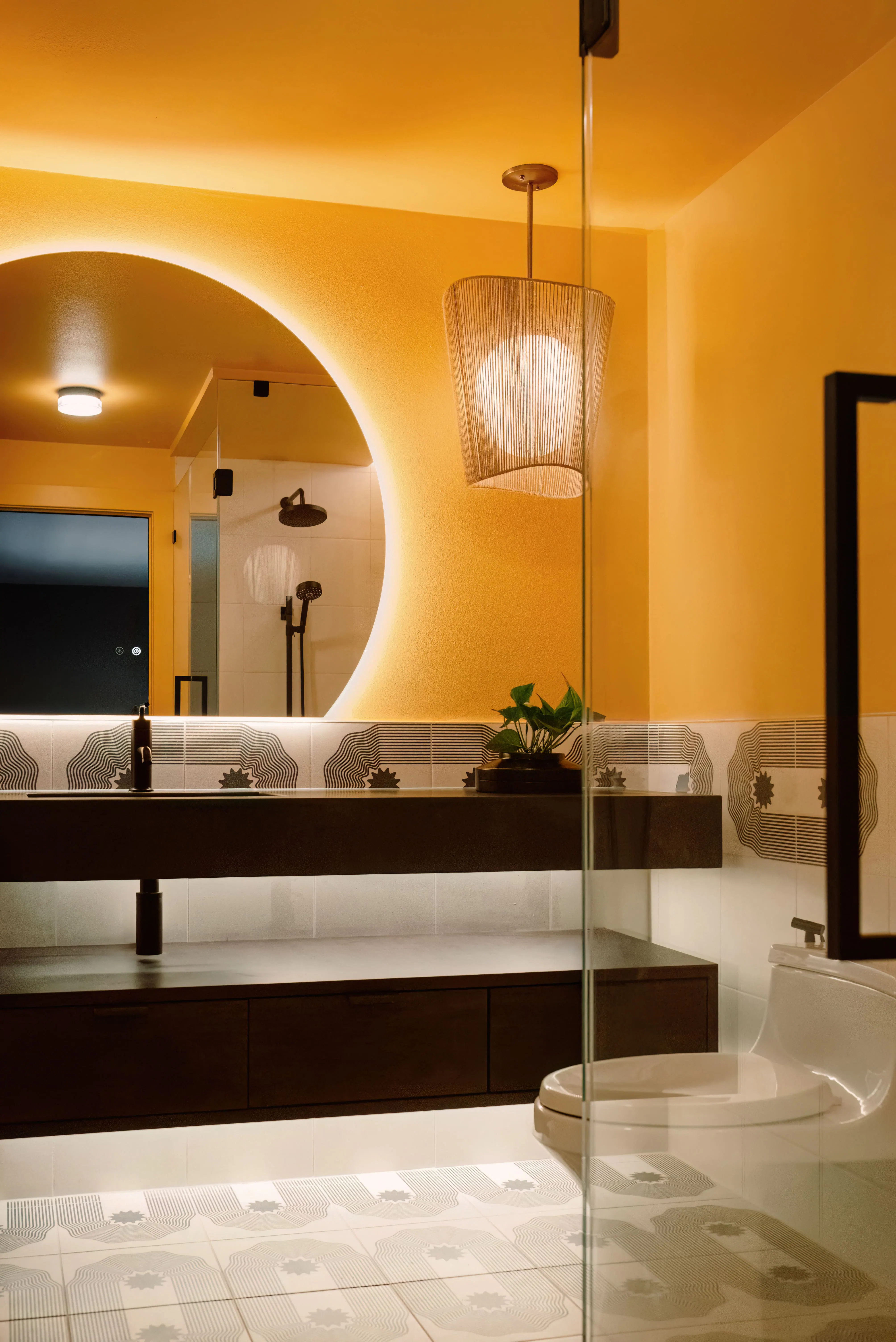 This bathroom by Persimmon Design is a powerful example of how a designer can completely transform the outcome of a remodel. The bathroom becomes an immersive retreat inspired by the warmth and sunlight of the client’s childhood in India. By introducing a curbless shower with seamless glass, immersive color drenching, layered lighting, and carefully aligned tilework, the remodel reimagined how it felt to experience every day.