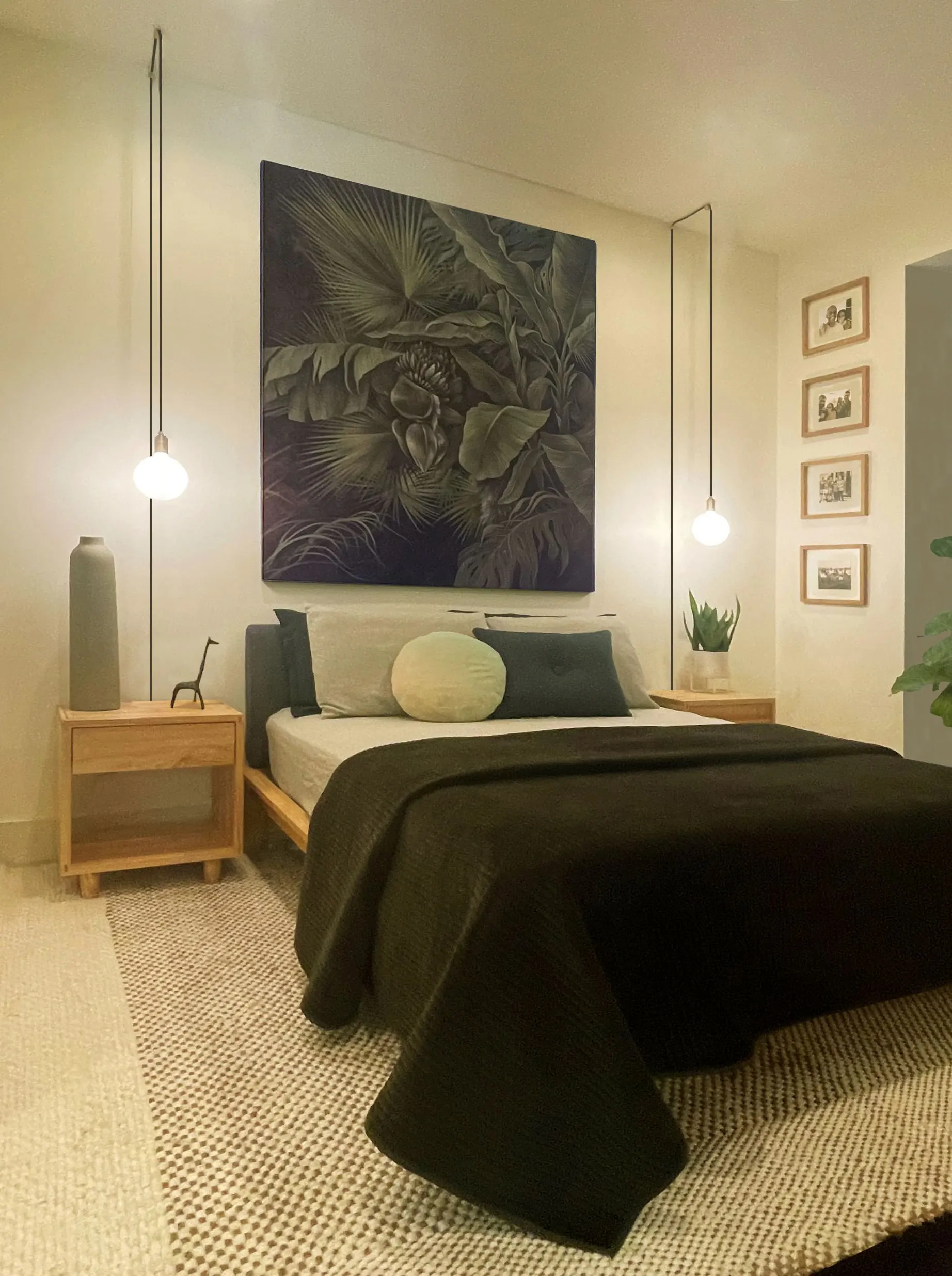 Bedroom interior design done by Persimmon Design A bed with green bedsheet and multiple pillows that match the color scheme. Painting over it.
