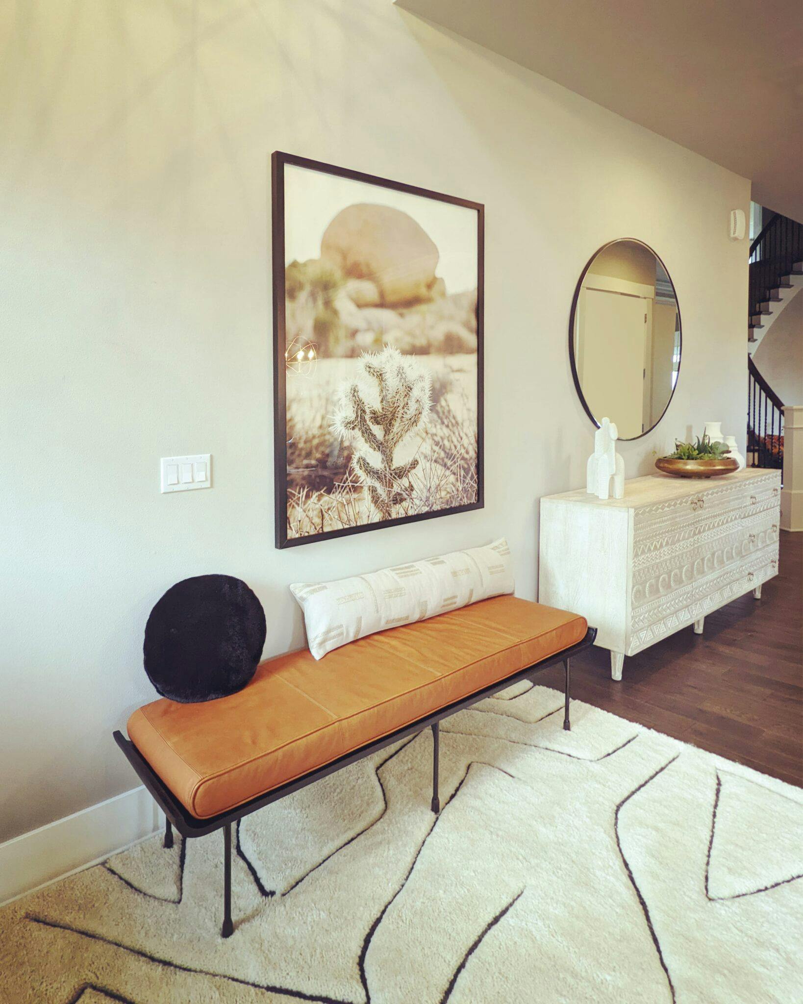 A rust leather bench on a soft plush rug