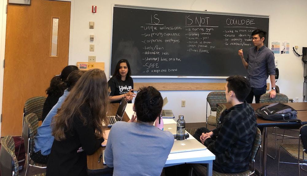 Bikebus team discussing the brand in a classroom