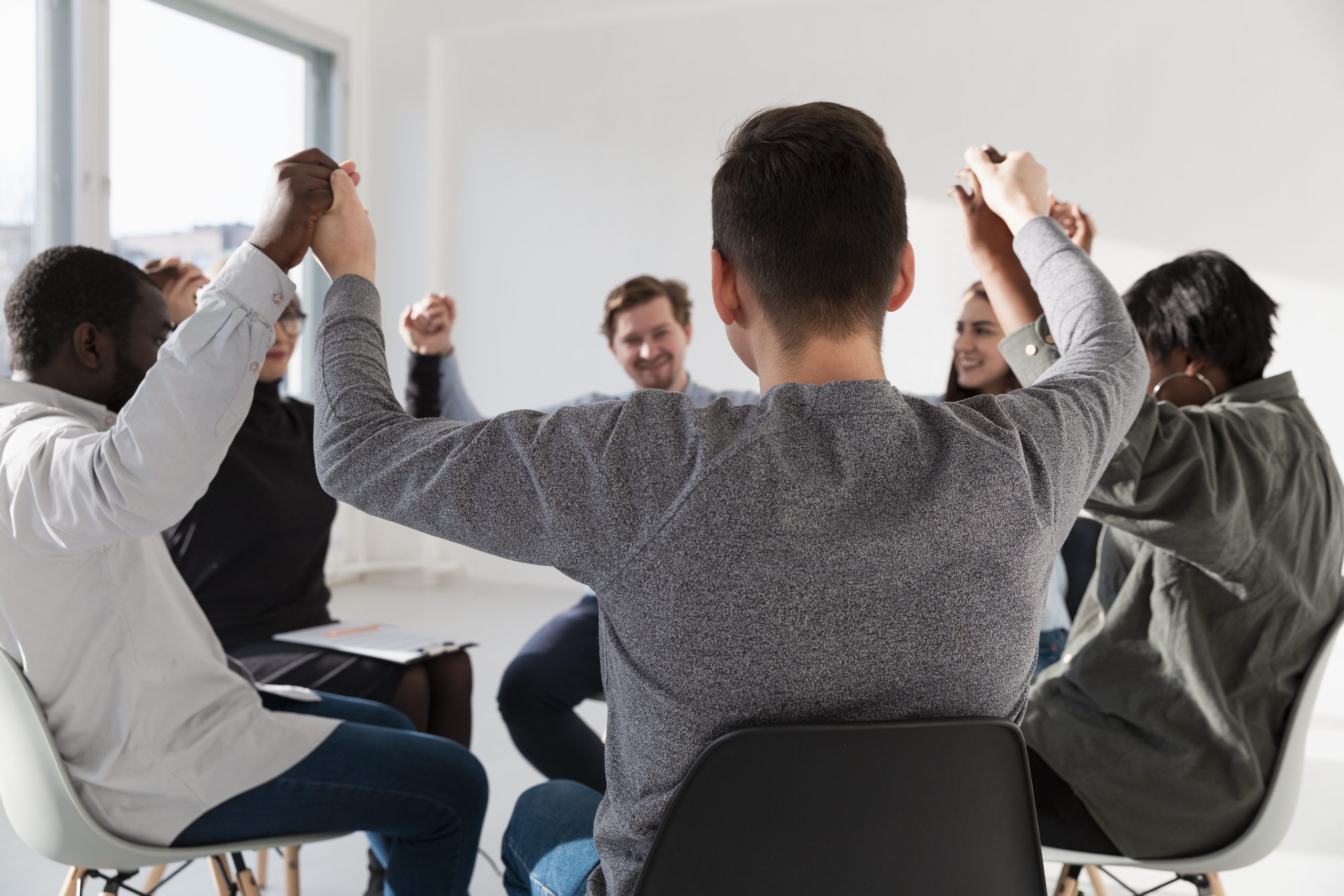 A group of learners holding hands in a circle