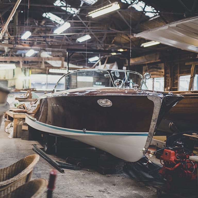 Riva boats for sale, starboard side view of Riva Ariston in workshop at Peter Freebody & Co