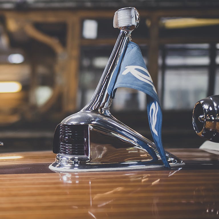 Riva pennant on forward deck of Riva in workshop at Peter Freebody & Co