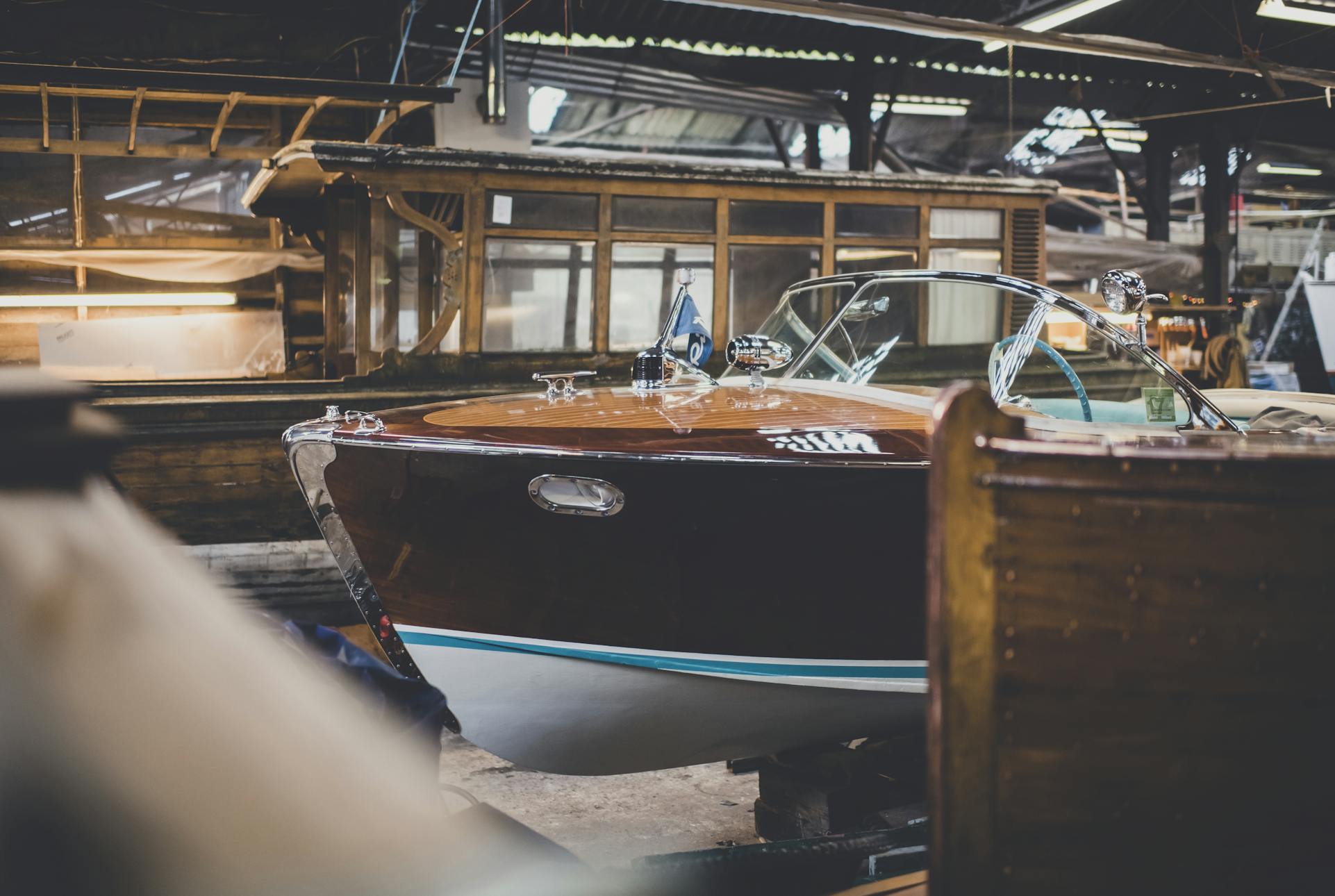 Riva boats for sale, side view of the bow of a Riva Ariston in the workshop at Peter Freebody & Co