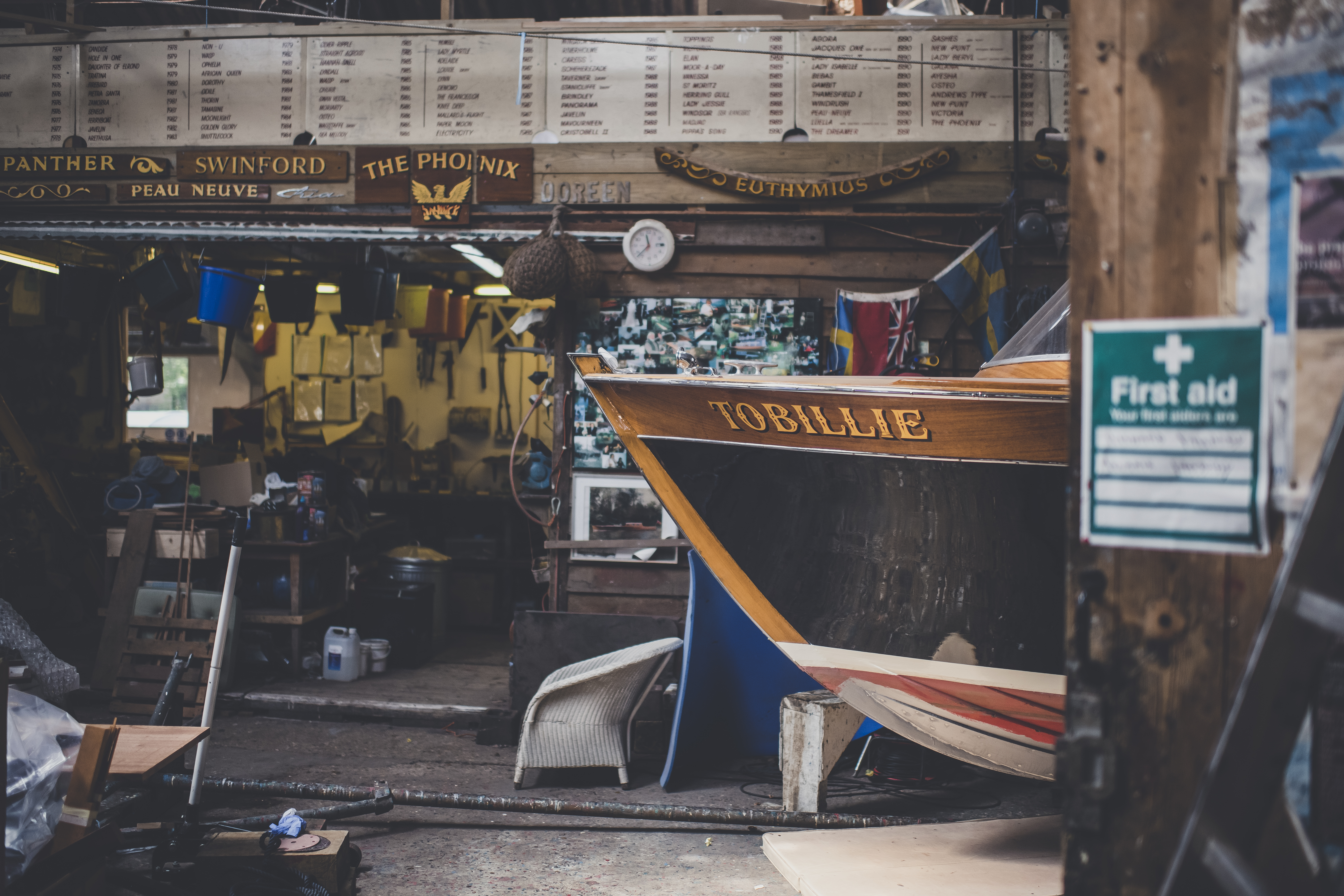 Wooden boat restoration, bow of cruiser on Freebody slipway with restoration boards behind