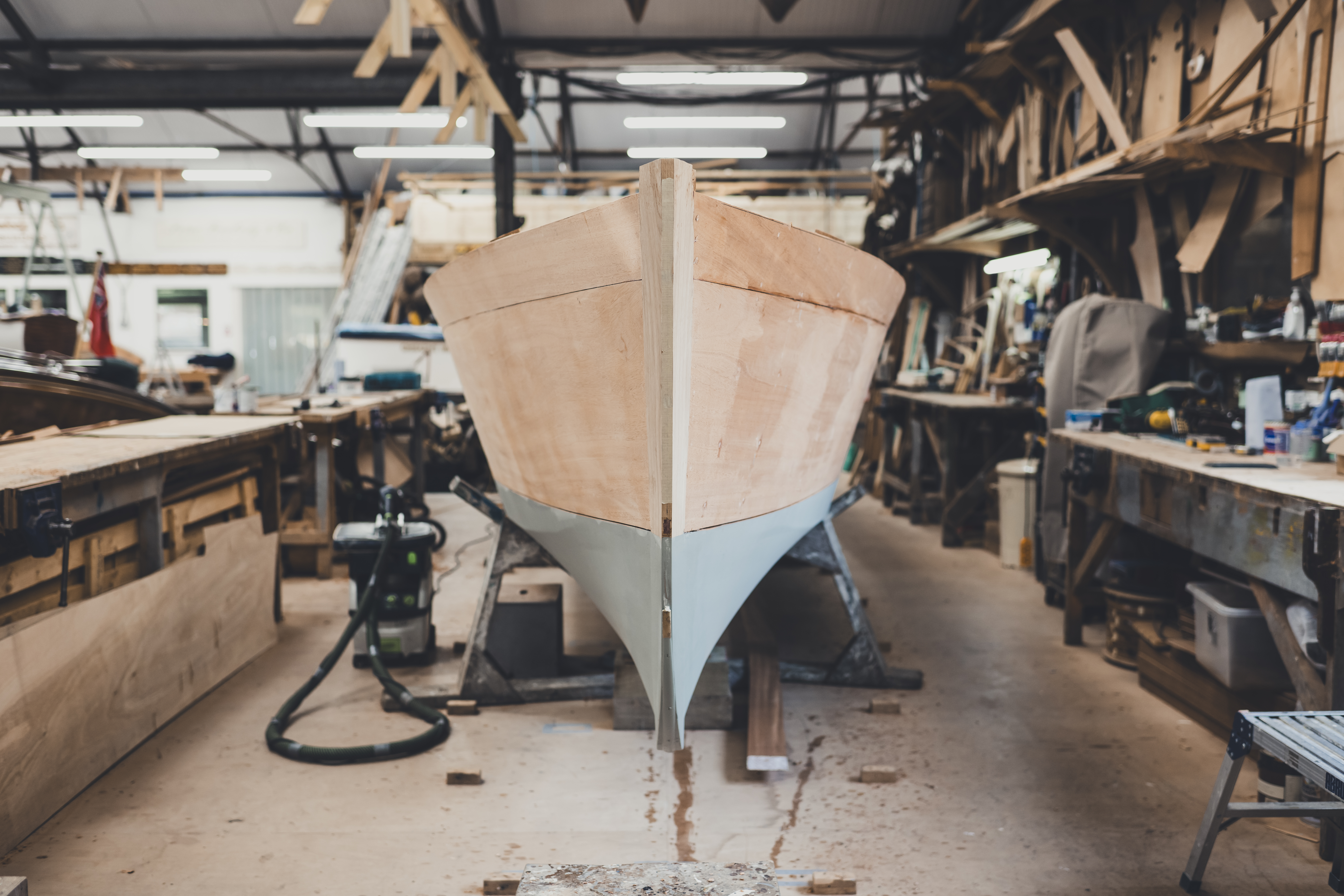 Luxury wooden boats for sale, bow view of Freebody Spirit slipper launch in build process in Hurley workshop 