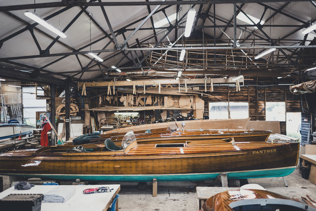 Wooden boat restoration, Gibbs launch in the workshop at Peter Freebody & Co for revarnishing
