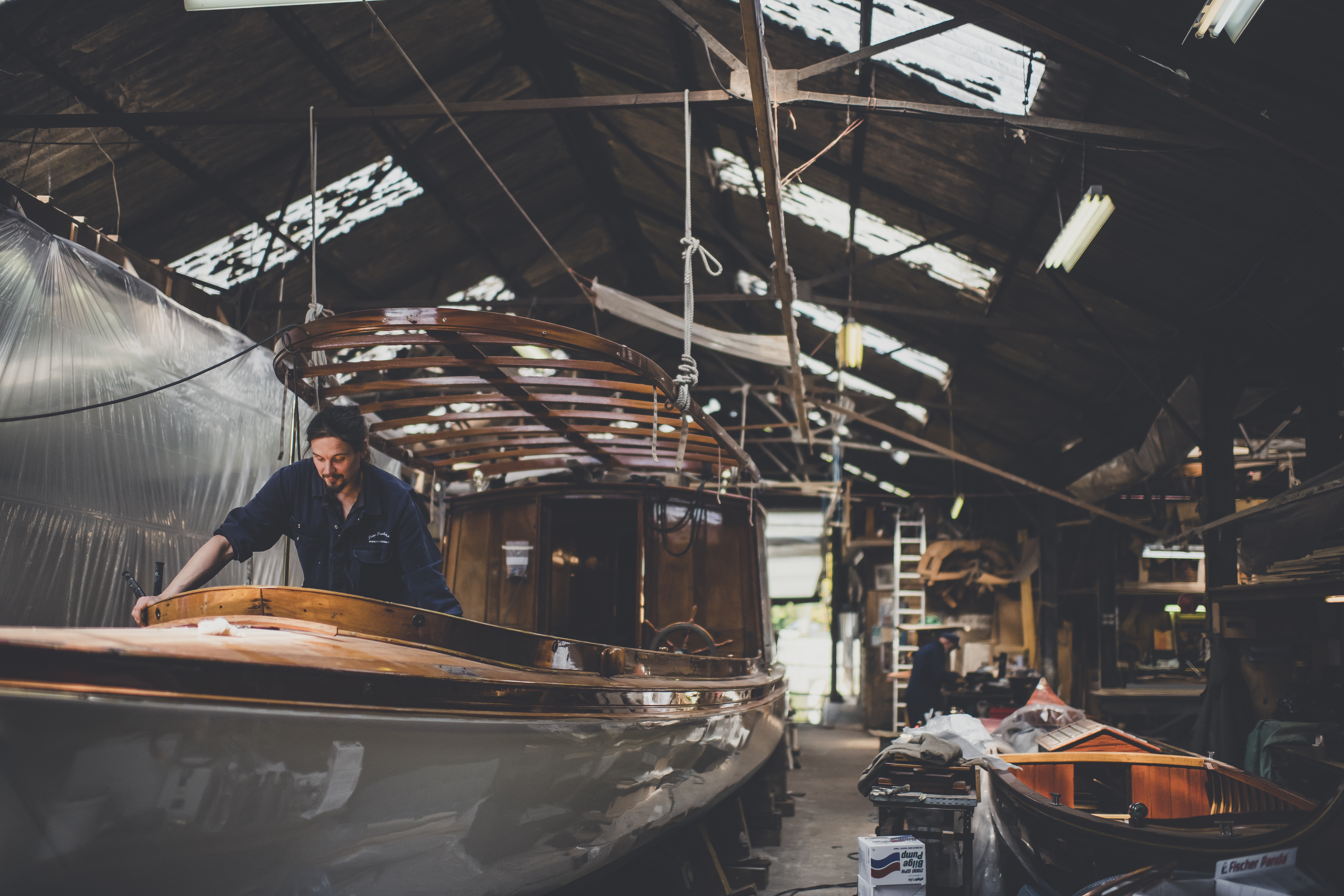 Wooden boat restoration, Alfred Burgoine saloon launch undergoing restoration and remodelling works in the workshops of Peter Freebody & Co 