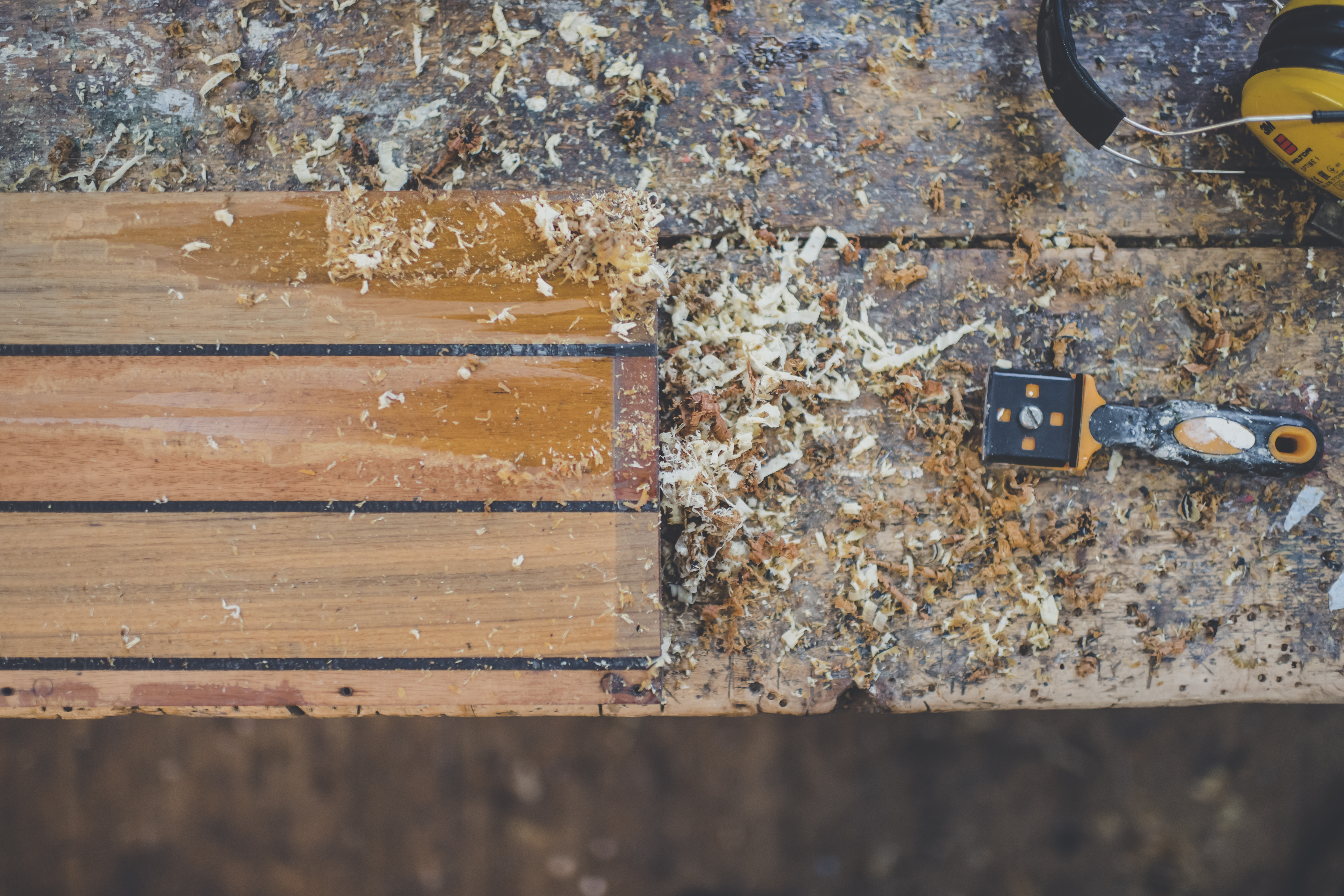 Wooden boat restoration, detail showing varnish removed from wooden hatch in Peter Freebody & Co workshop