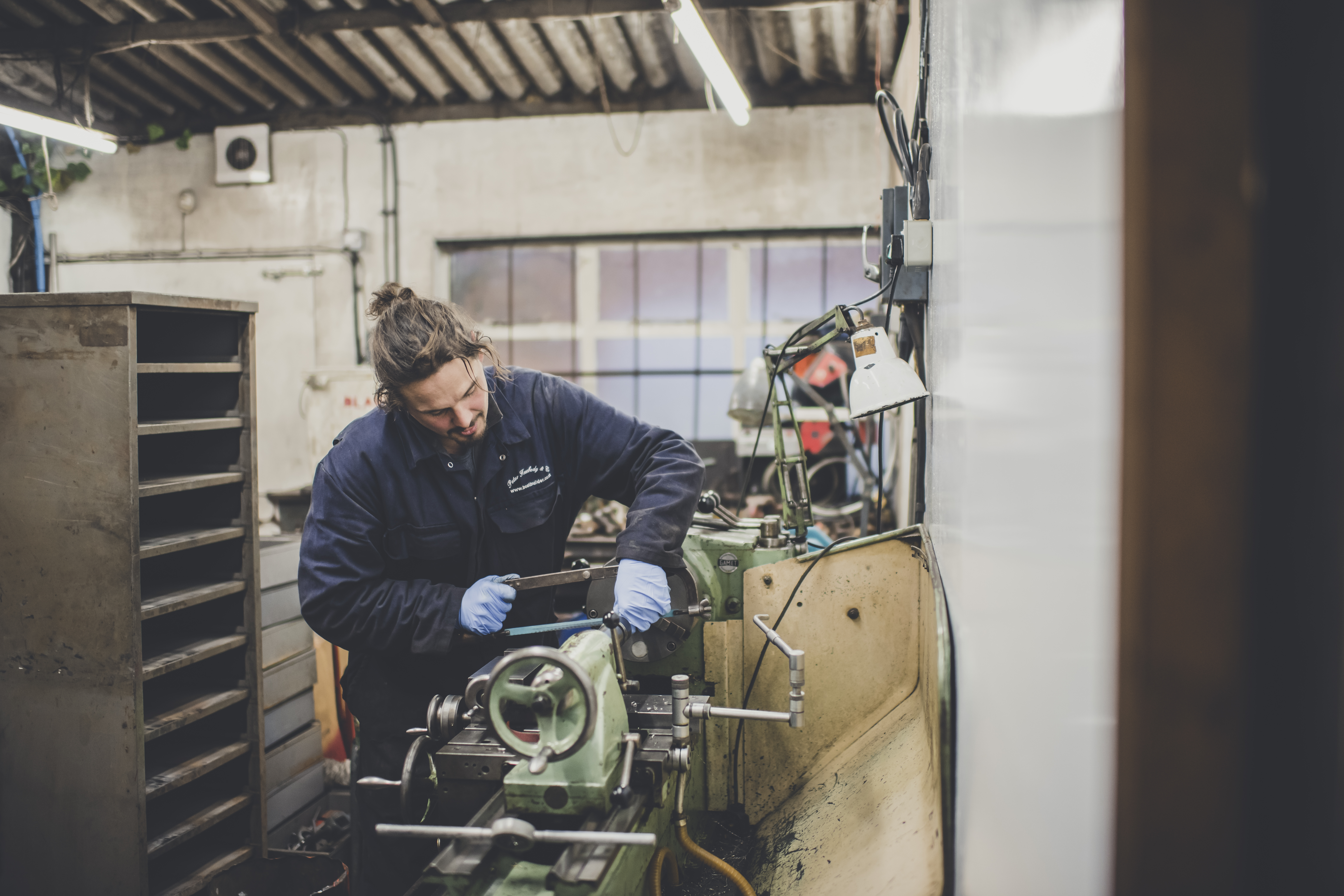 Wooden boat restoration, Freebody engineer on lathe in Freebody engineering workshop