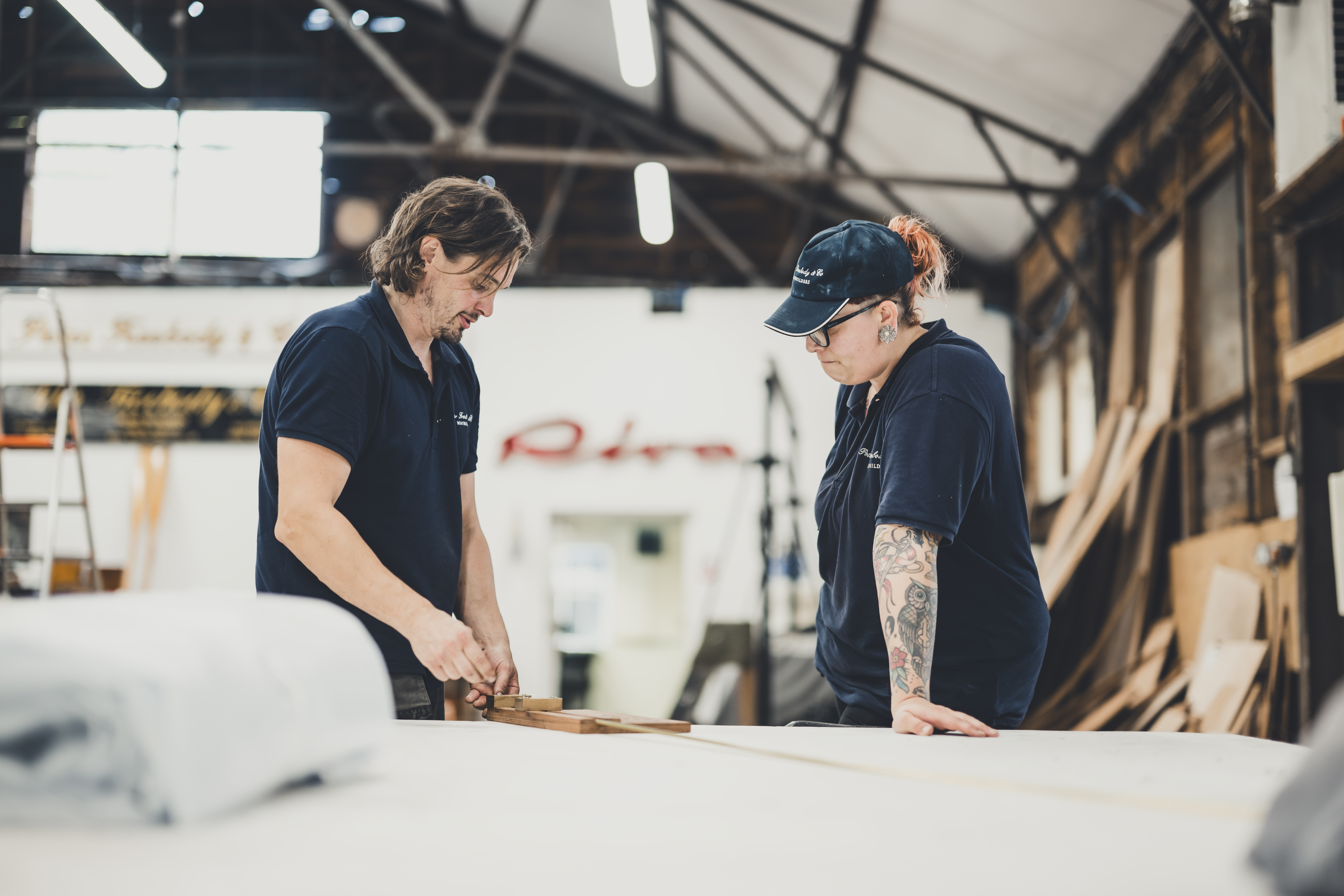 Freebody marine engineers discussing works with Riva signage in background 