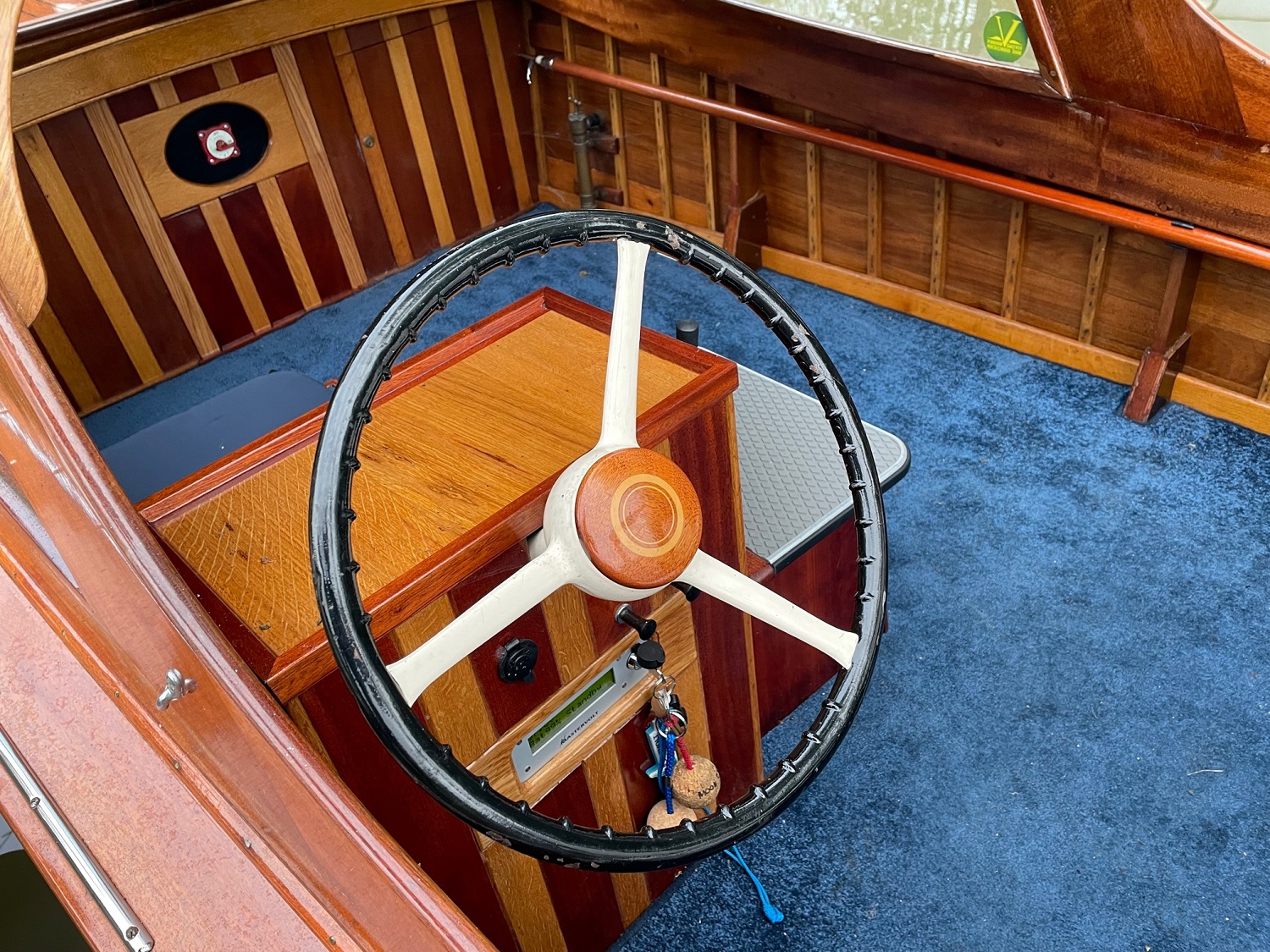 Wooden day boat for sale, helm position with steering wheel