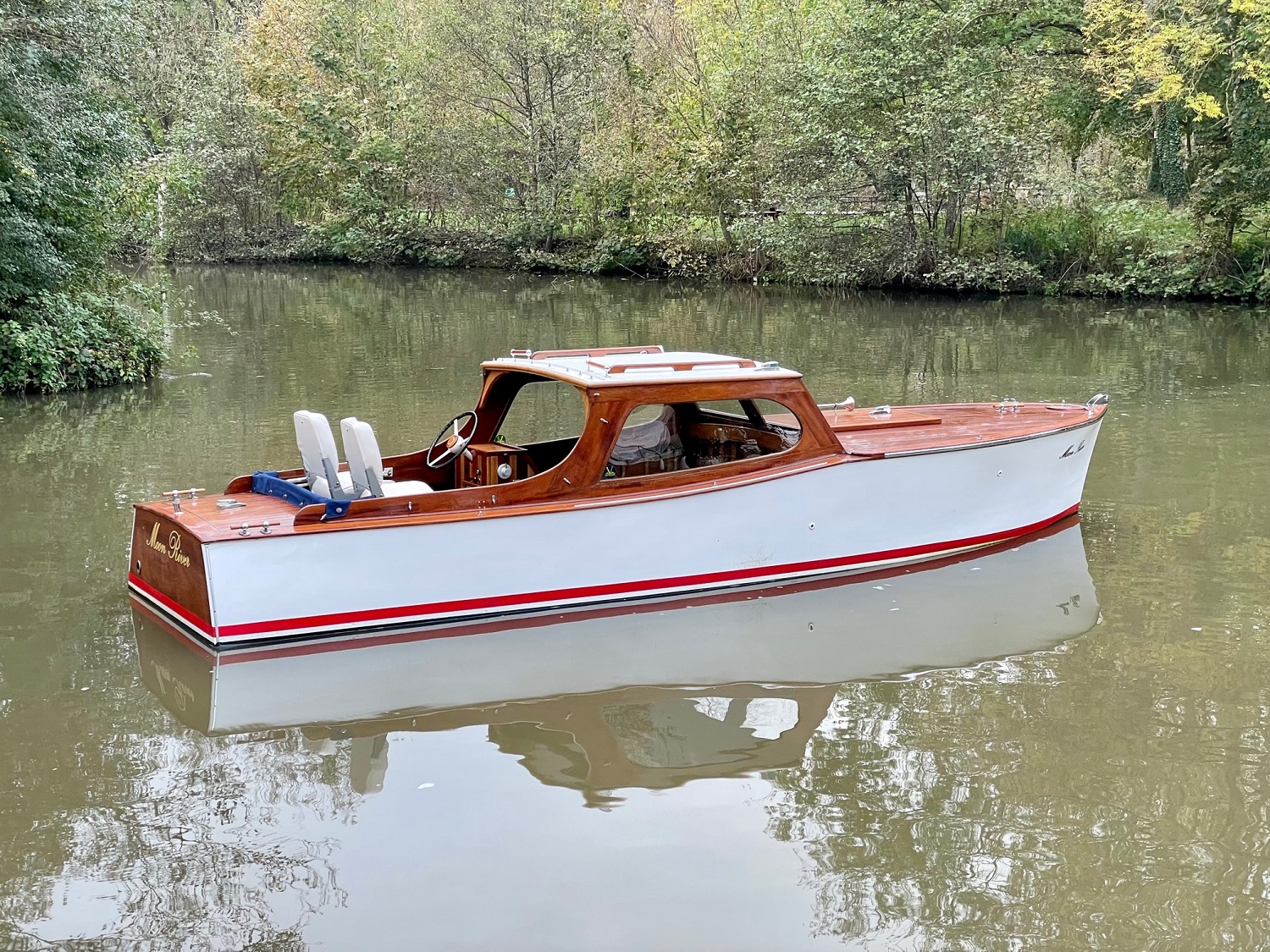 Wooden day boat for sale, side profile afloat on river Thames