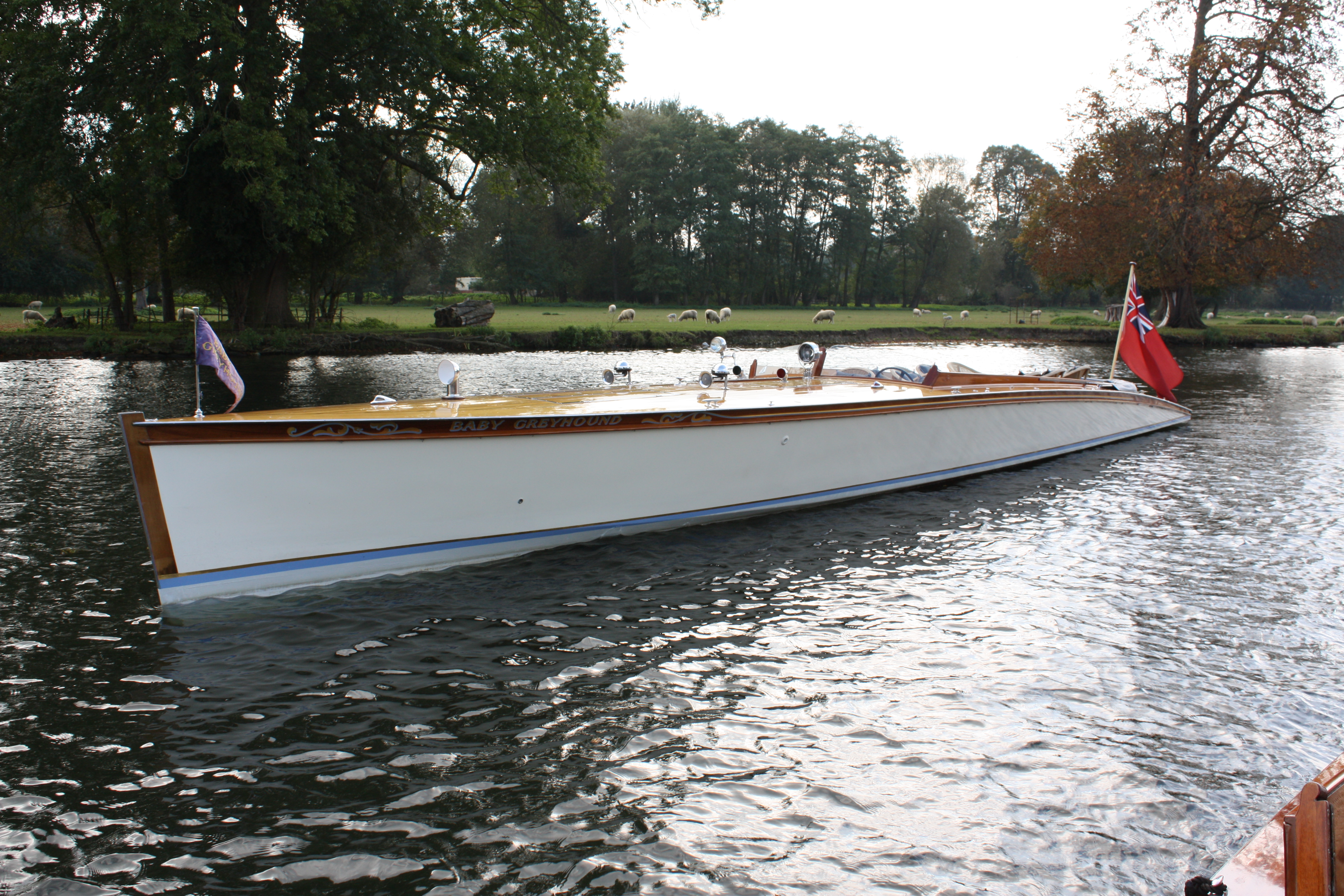 Slipper launch for sale, side profile view from bow looking aft with flag flying