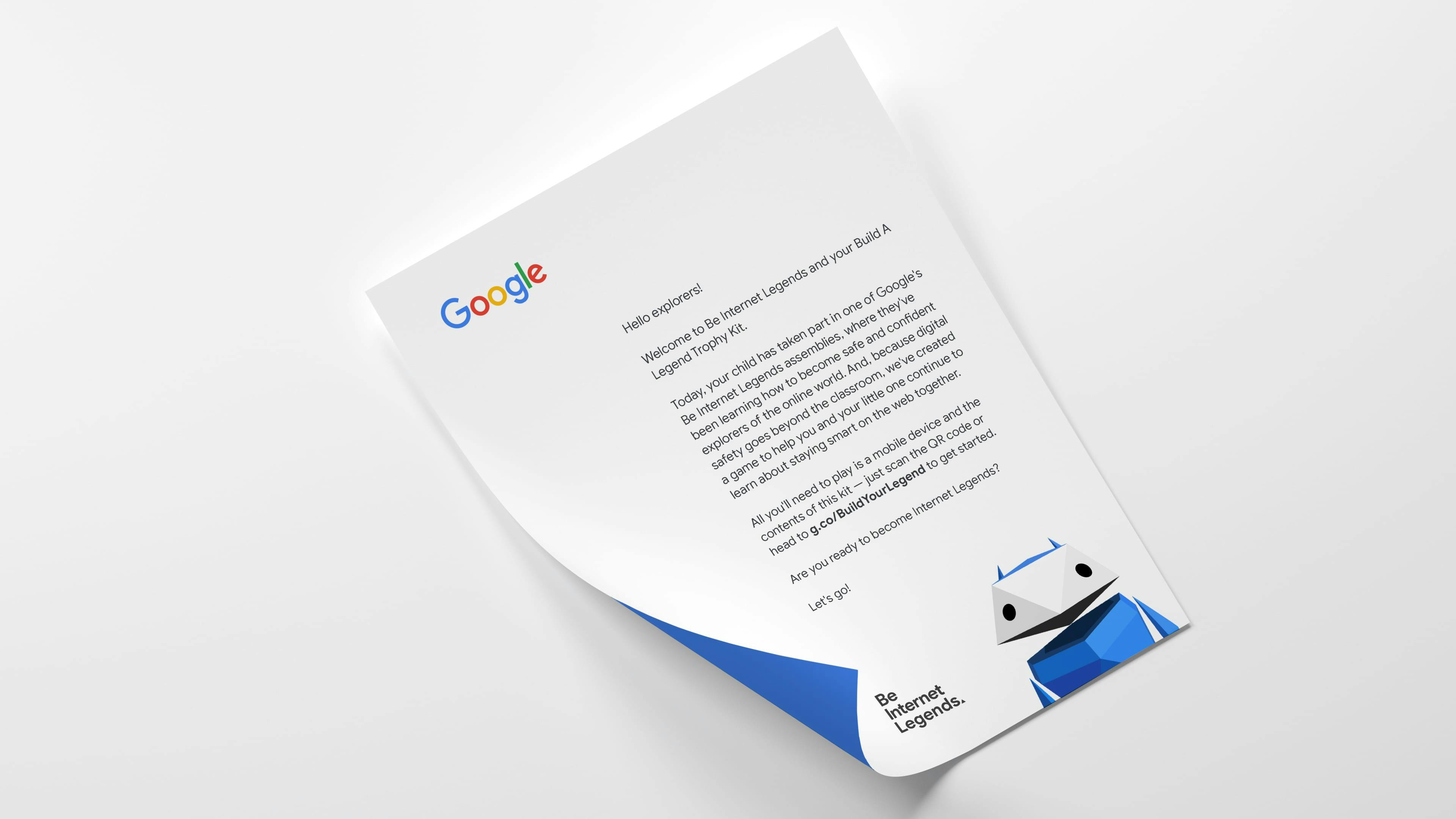 A slightly curled sheet of paper serving as a welcome letter for Google's 'Be Internet Legends' program. The letterhead features the Google logo, and the body of the text explains the 'Build A Legend' kit and digital safety game. The bottom of the letter has a blue graphic border and features a geometric character illustration and the text 'Be Internet Legends'.