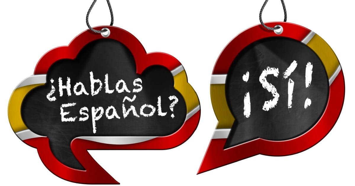 Representação gráfica de duas placas de balões de fala com as frases "Hablas Español?" e "Si".