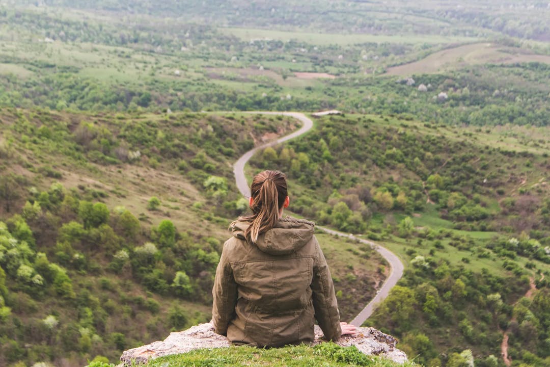 A woman looking out over a path in front of her