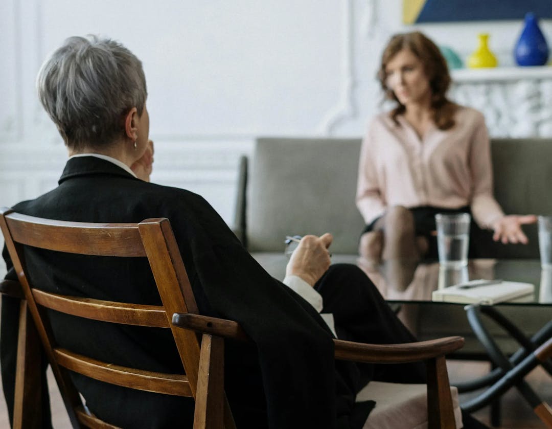 A therapist listening to their client speaking