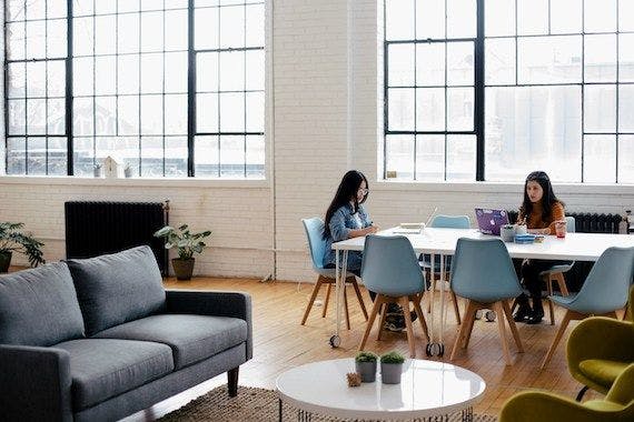 Office setting with workers at a table.