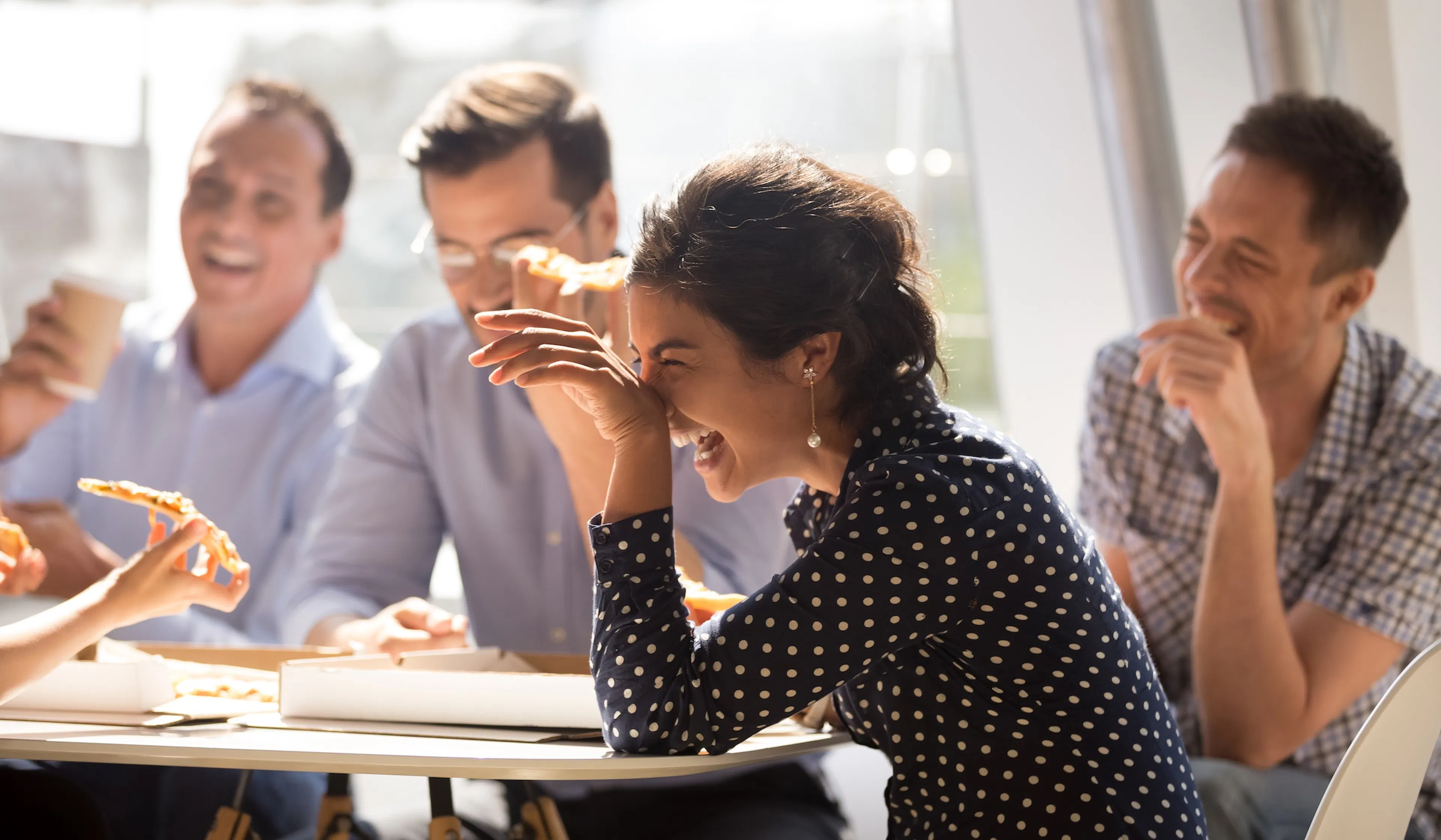 woman laughing eating pizza