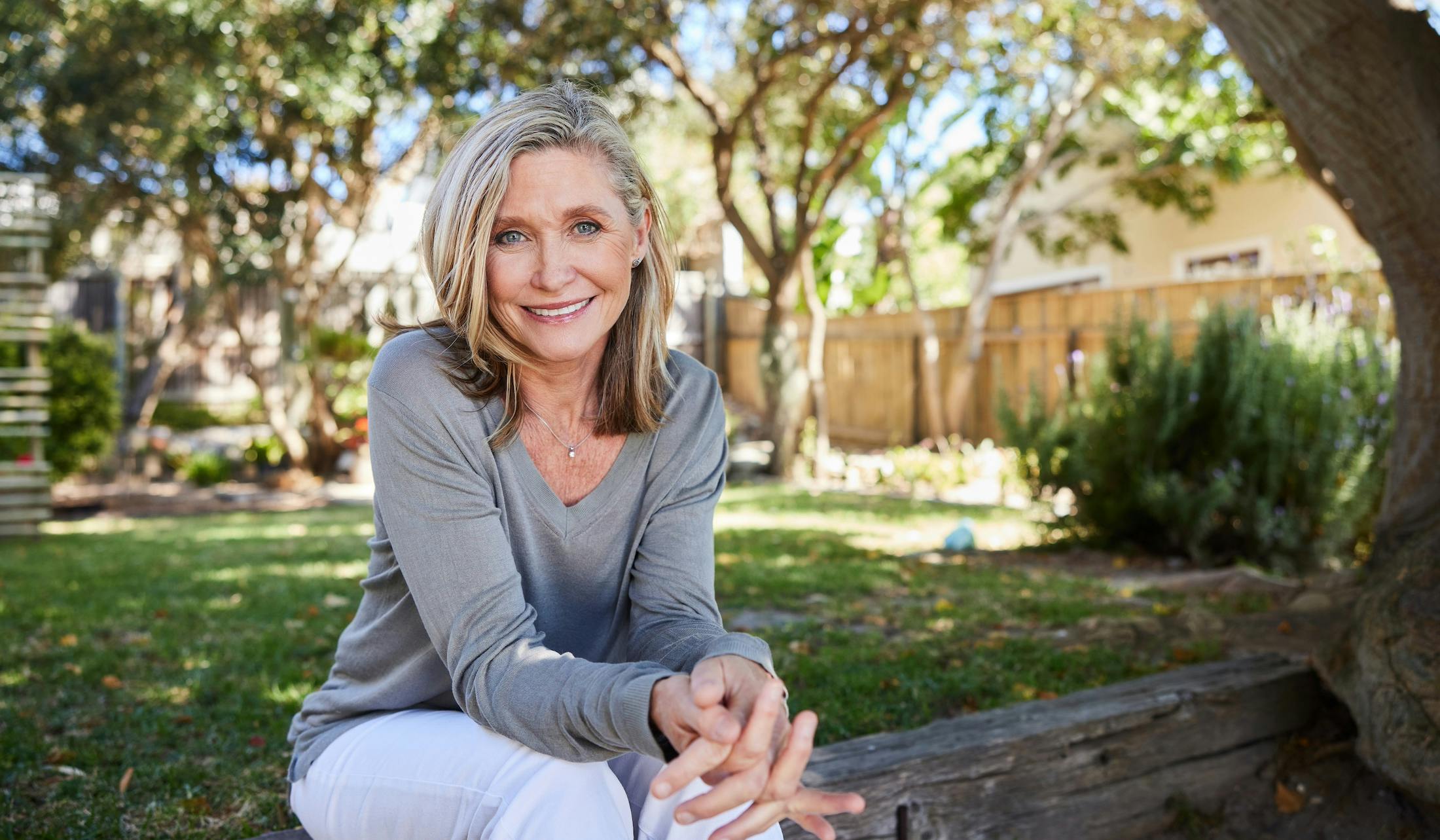 mature woman sitting outside smiling
