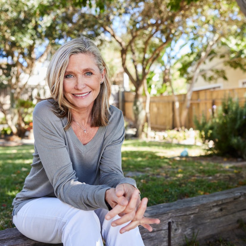 mature woman sitting outside smiling