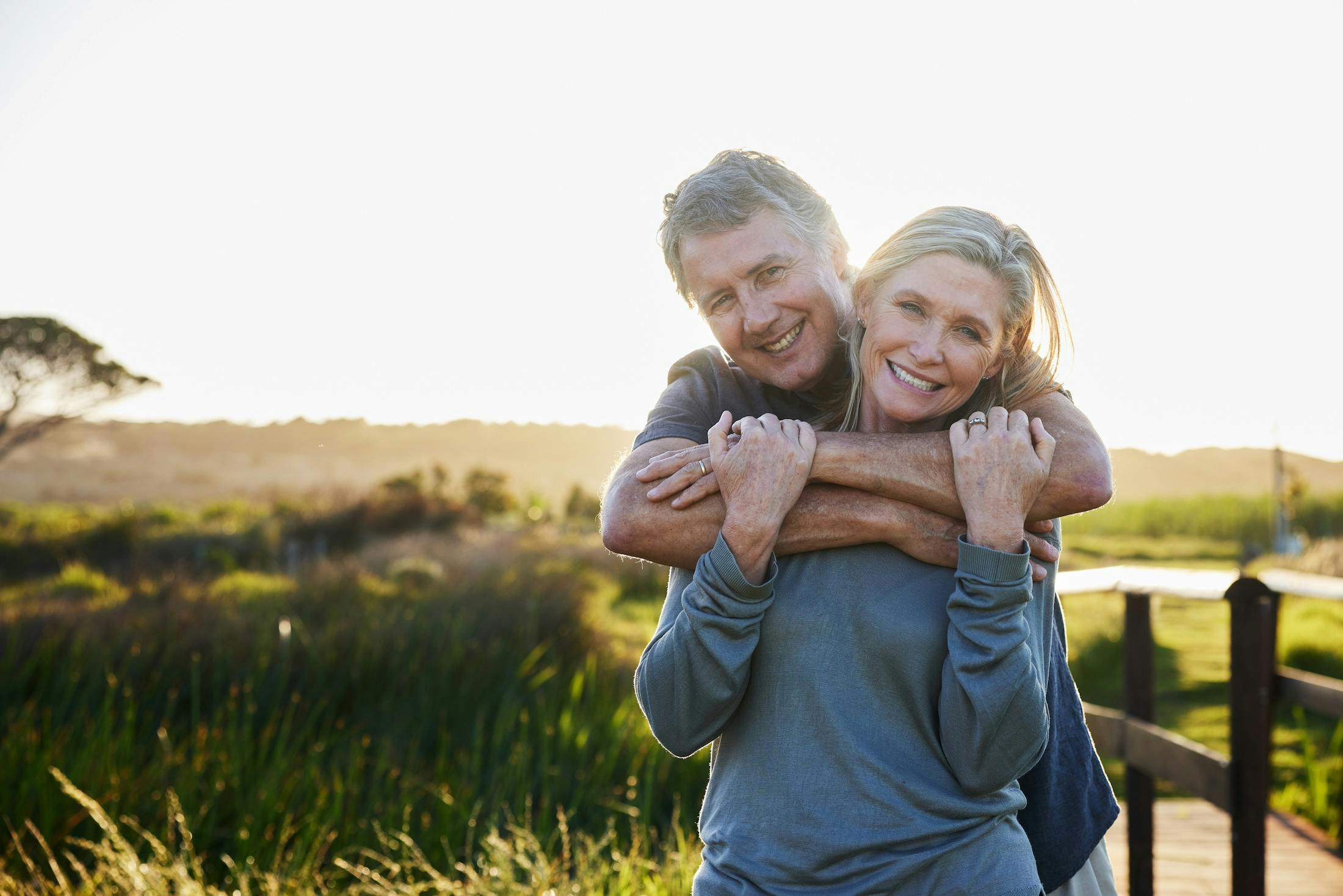 happy middle age couple at sunset