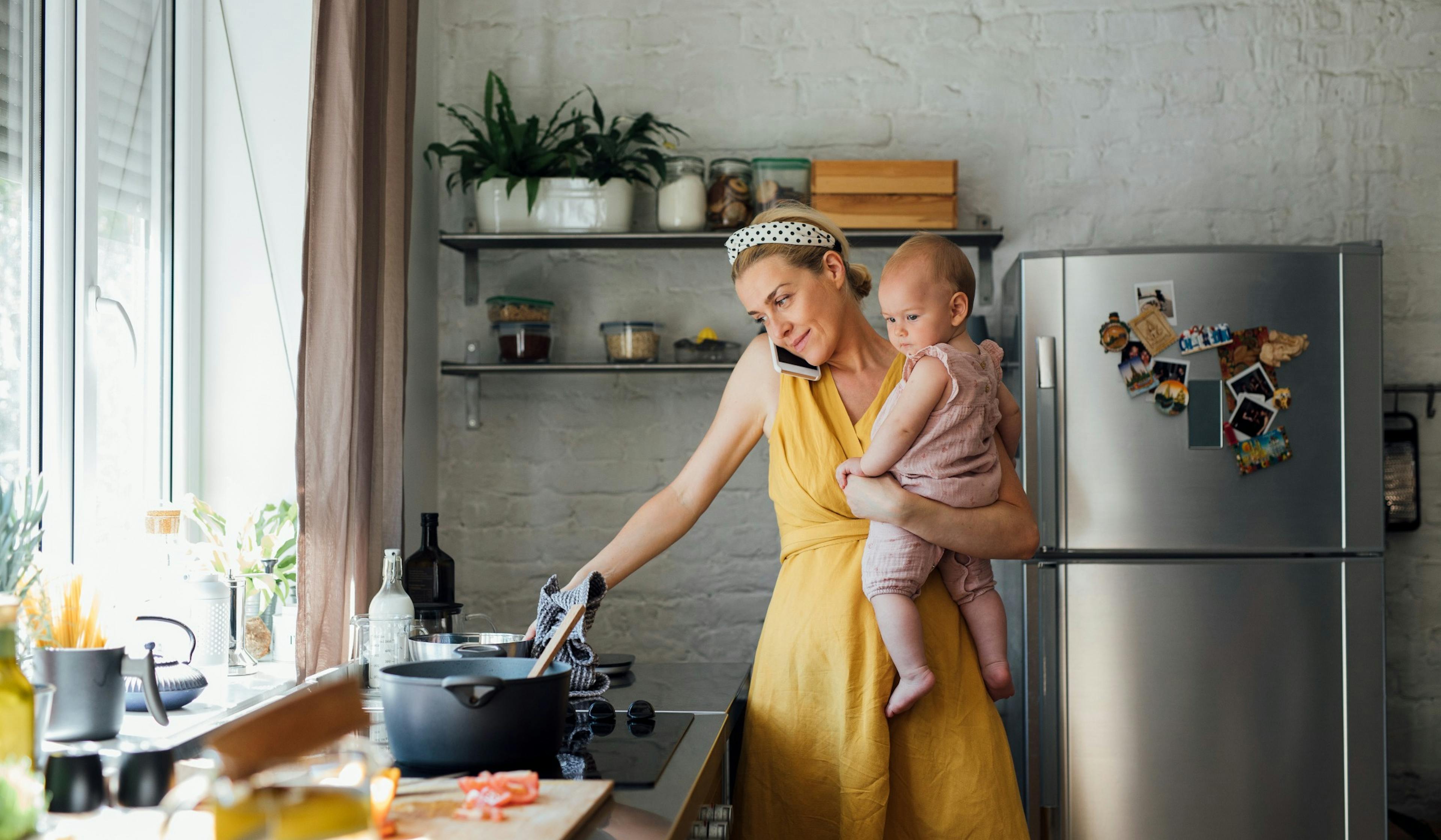 beautiful mom in the kitchen with baby