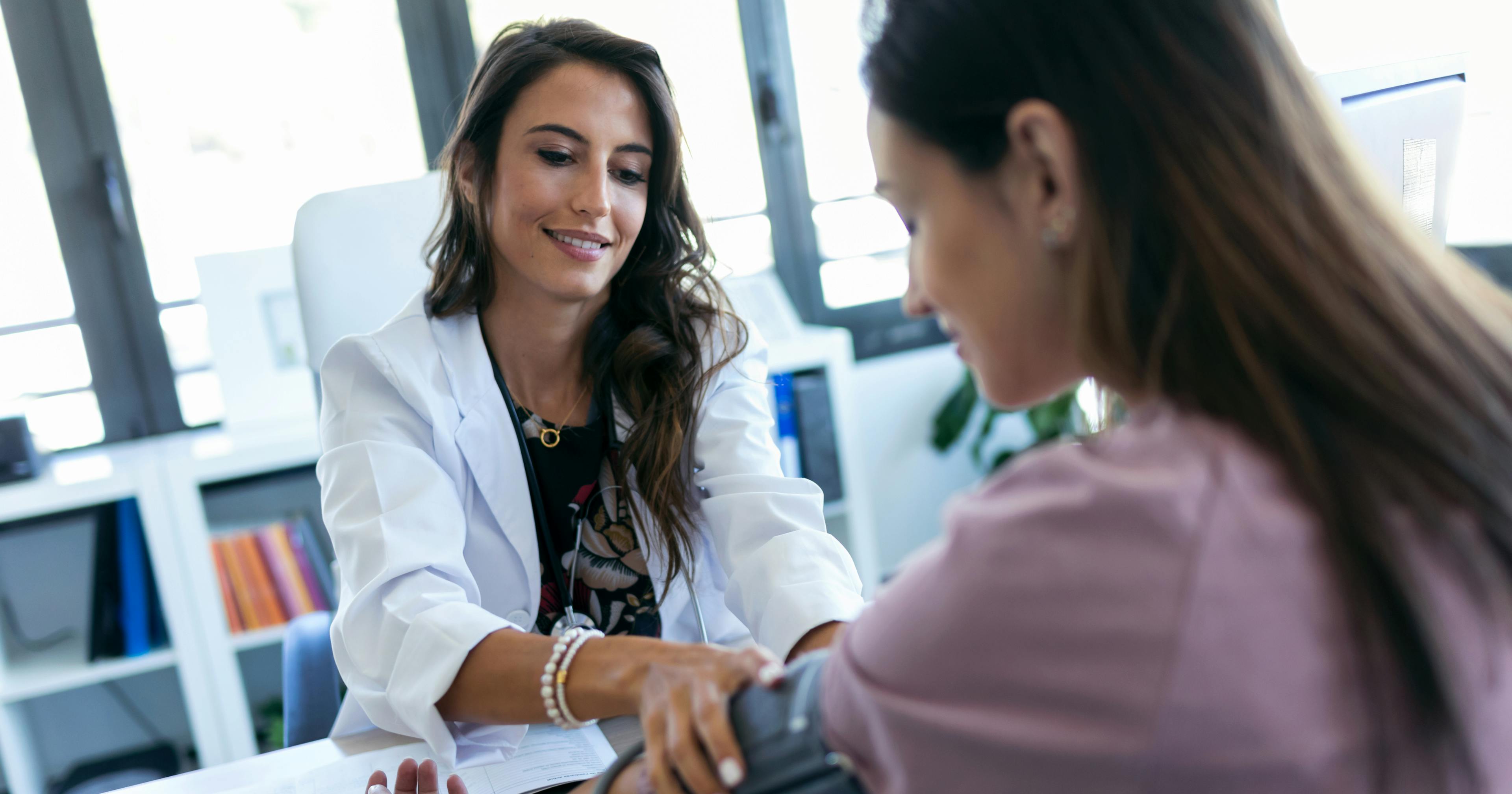 checking the blood pressure of a patient