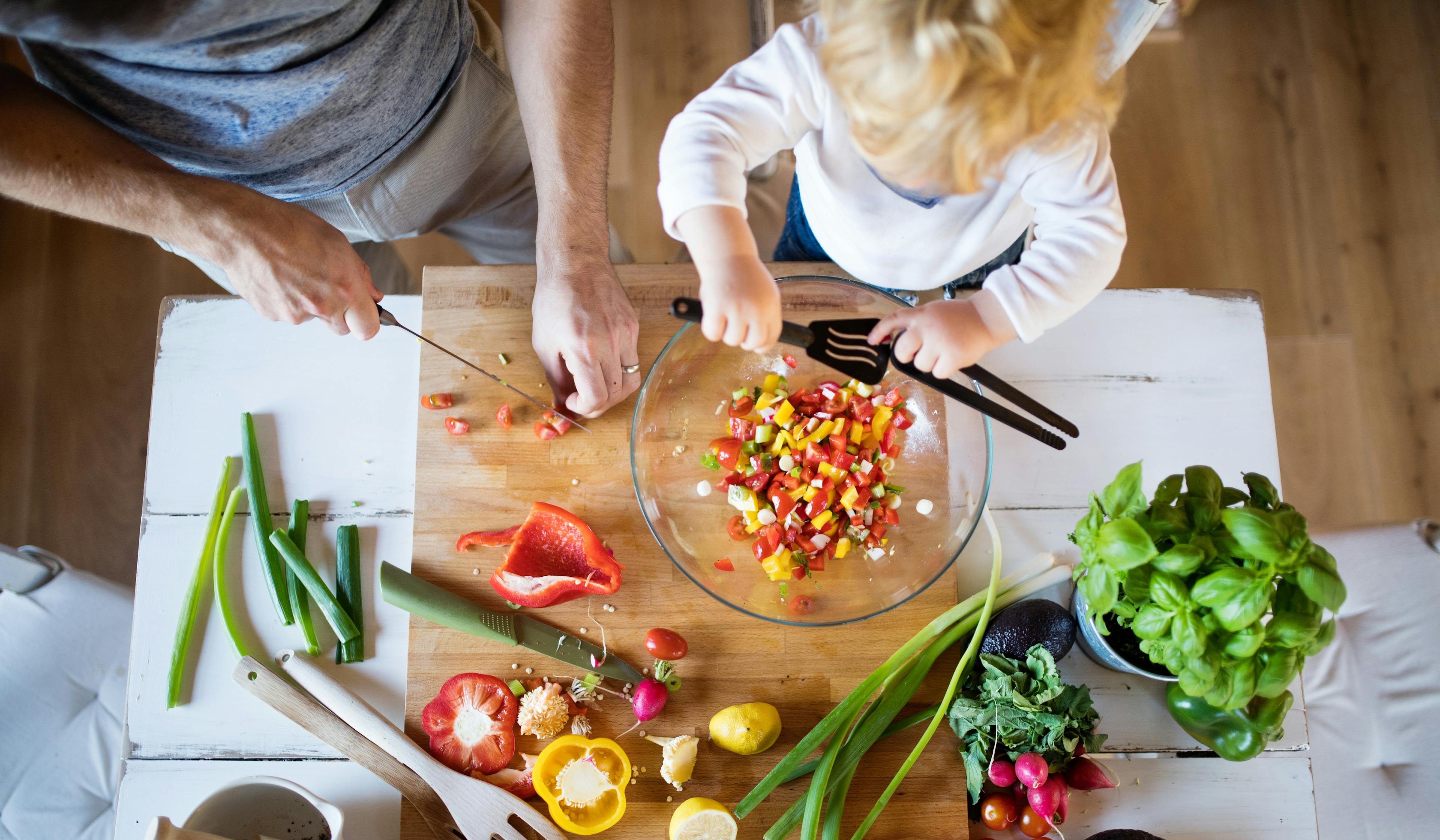 Young father with a toddler boy cooking