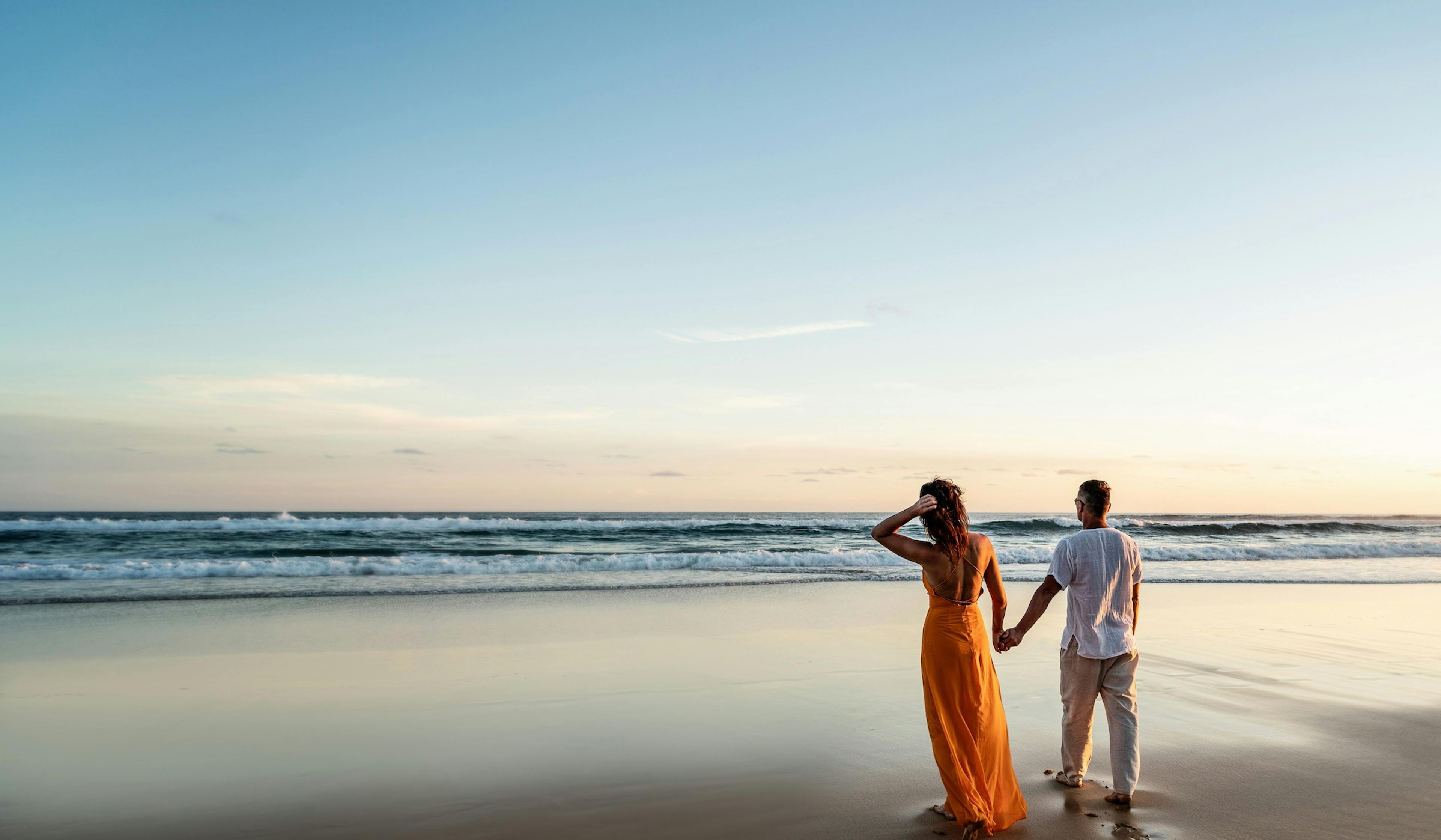 romantic couple walking on the beach