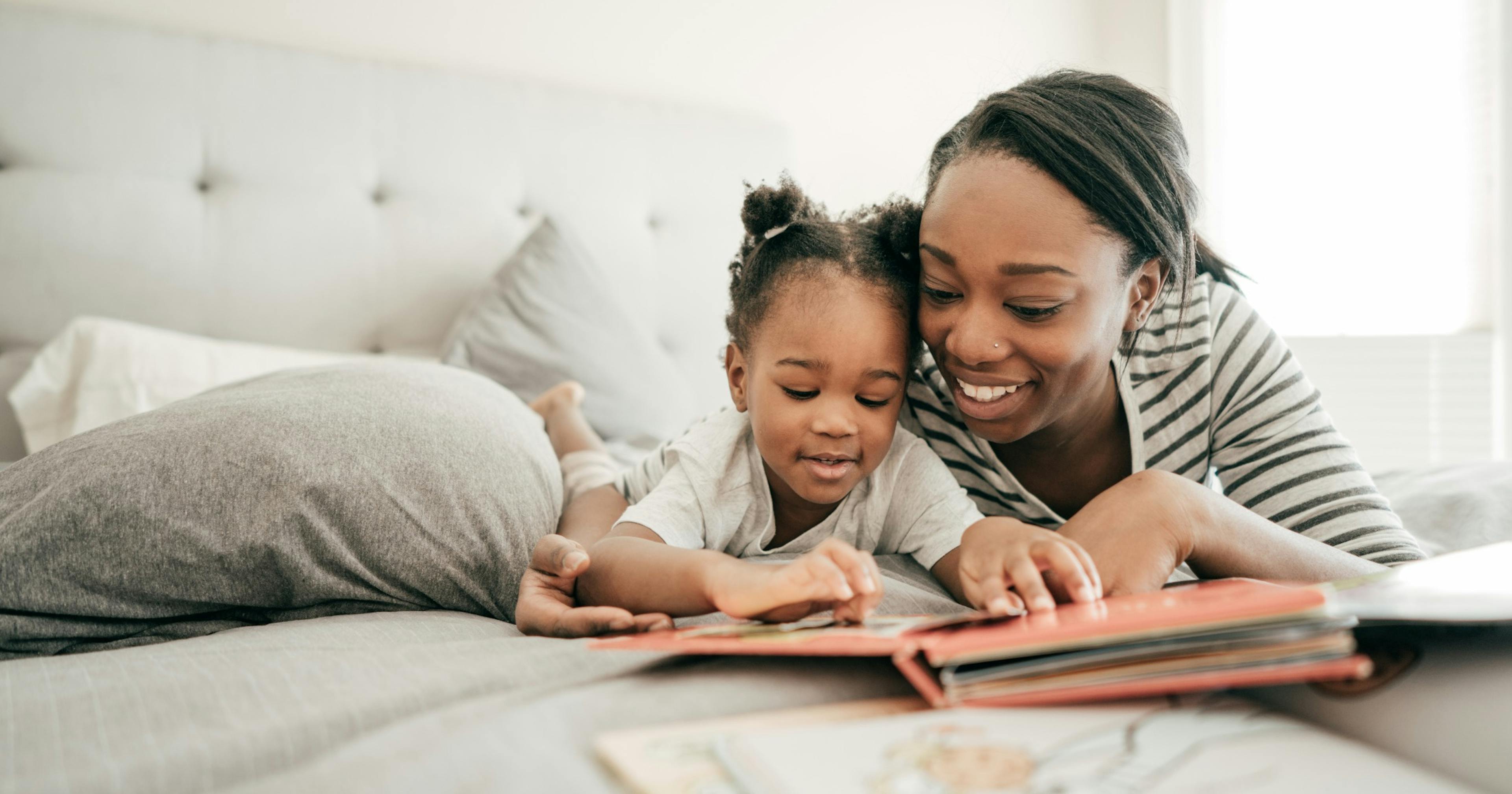 Mom and daughter reading a book.