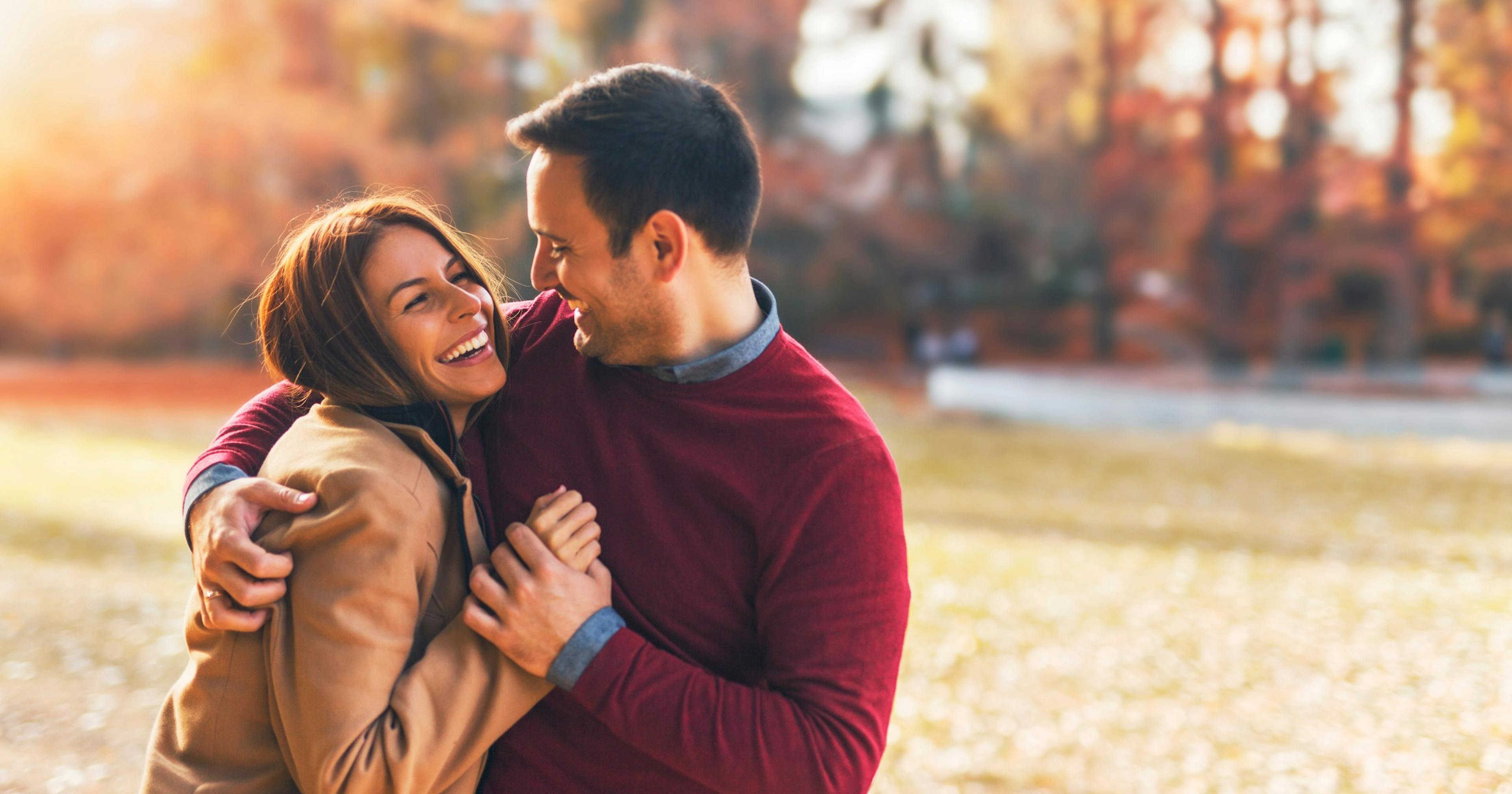 Happy couple outside during the fall.