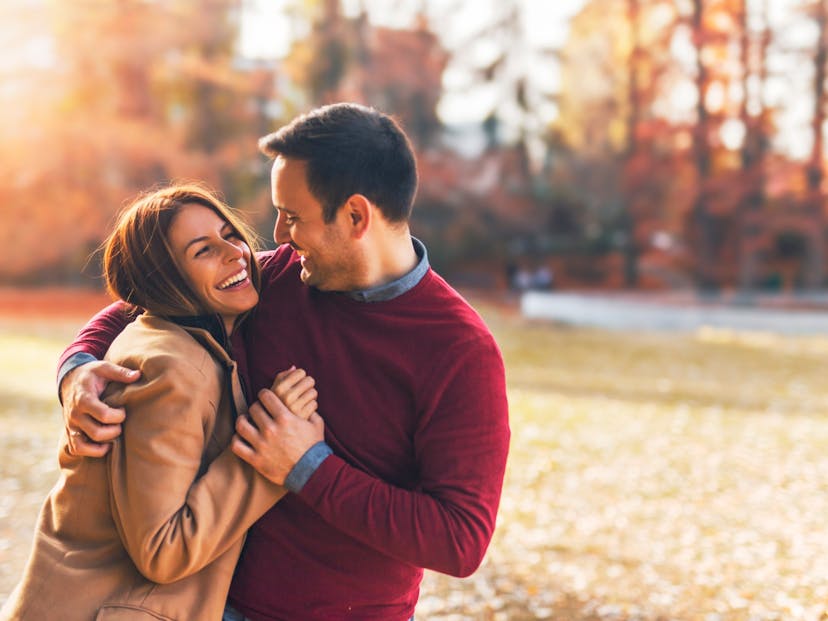 Happy couple outside during the fall.