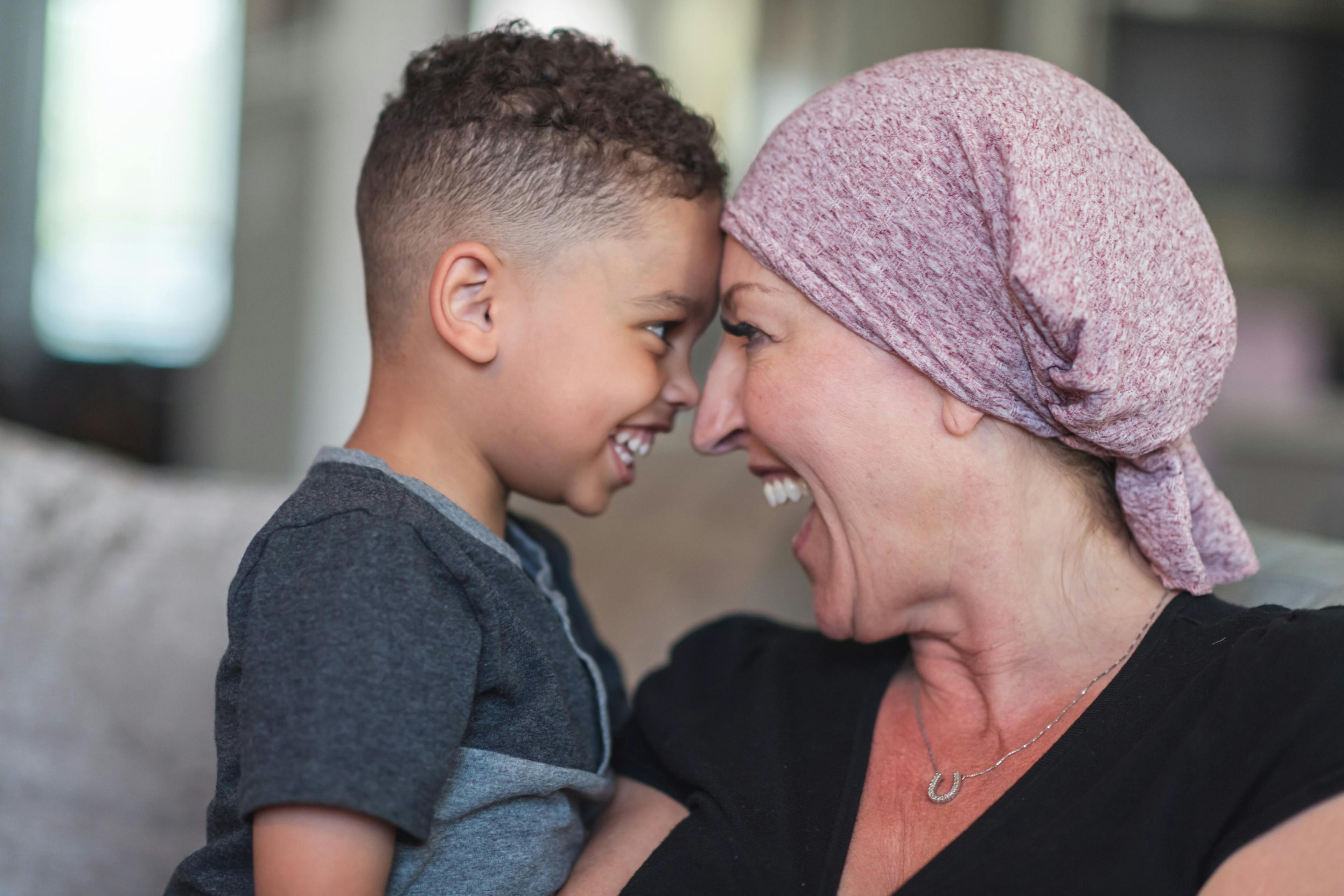 Woman with cancer spends precious time with her playful son.