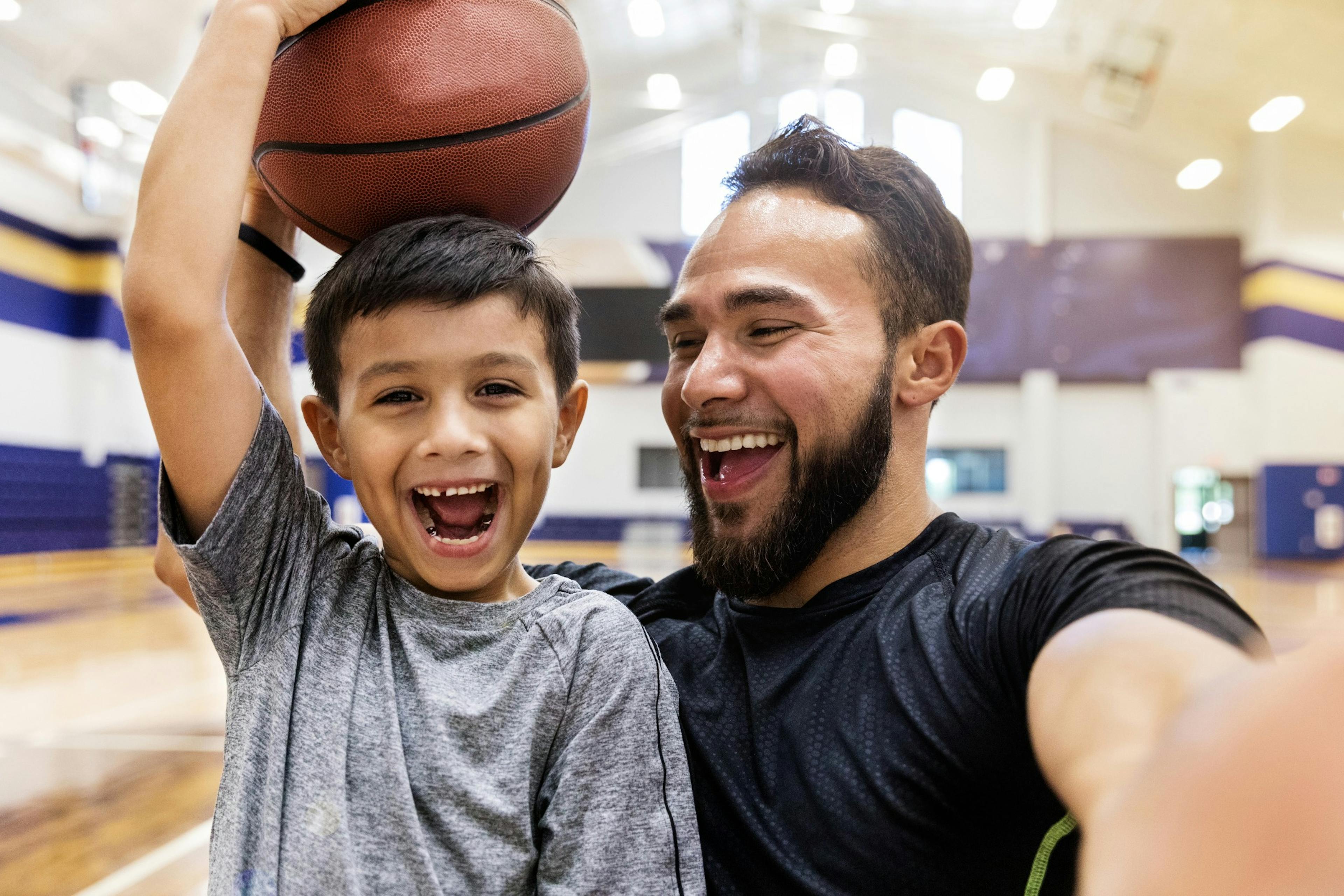 father and son playing basketball