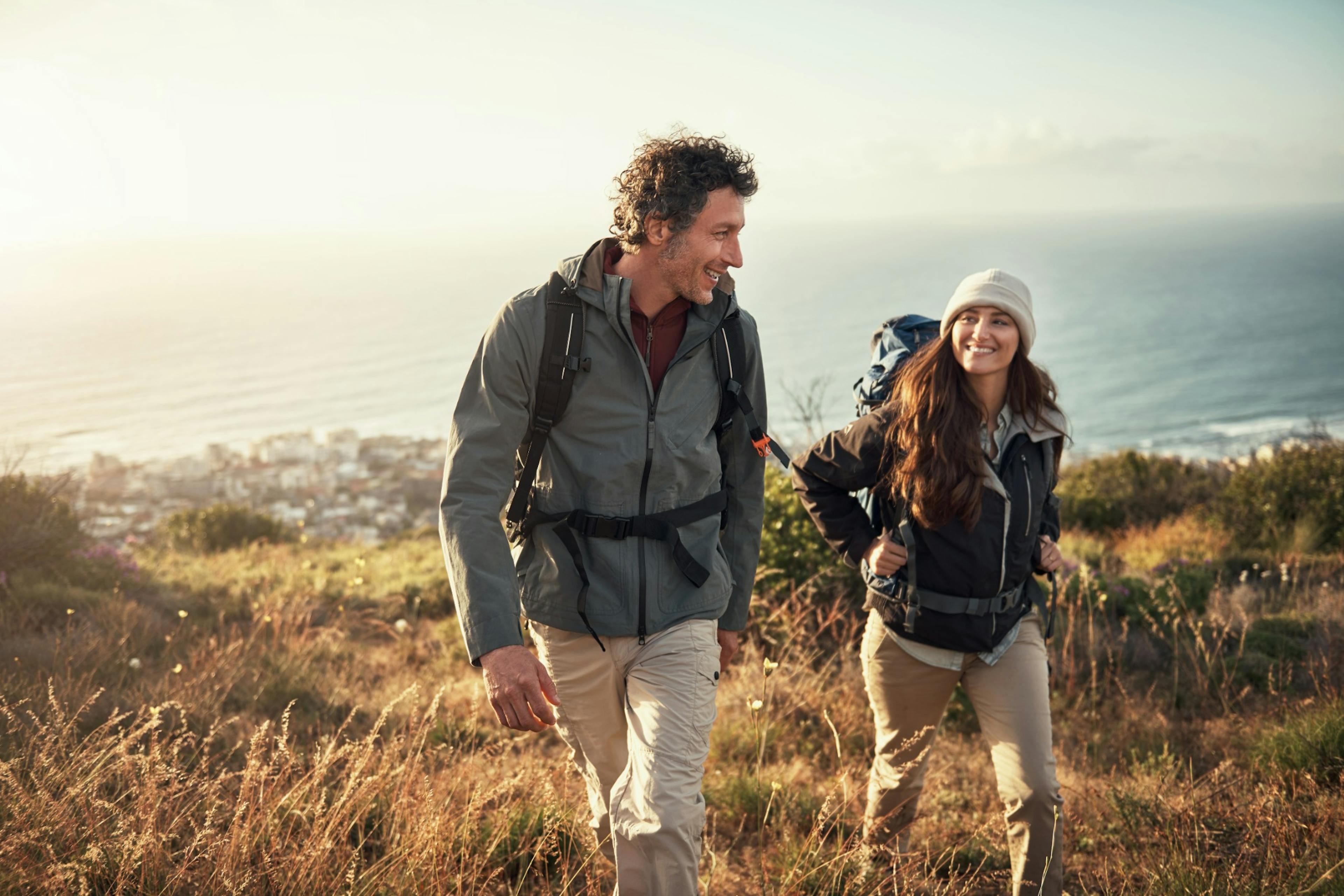 couple hiking up a hill