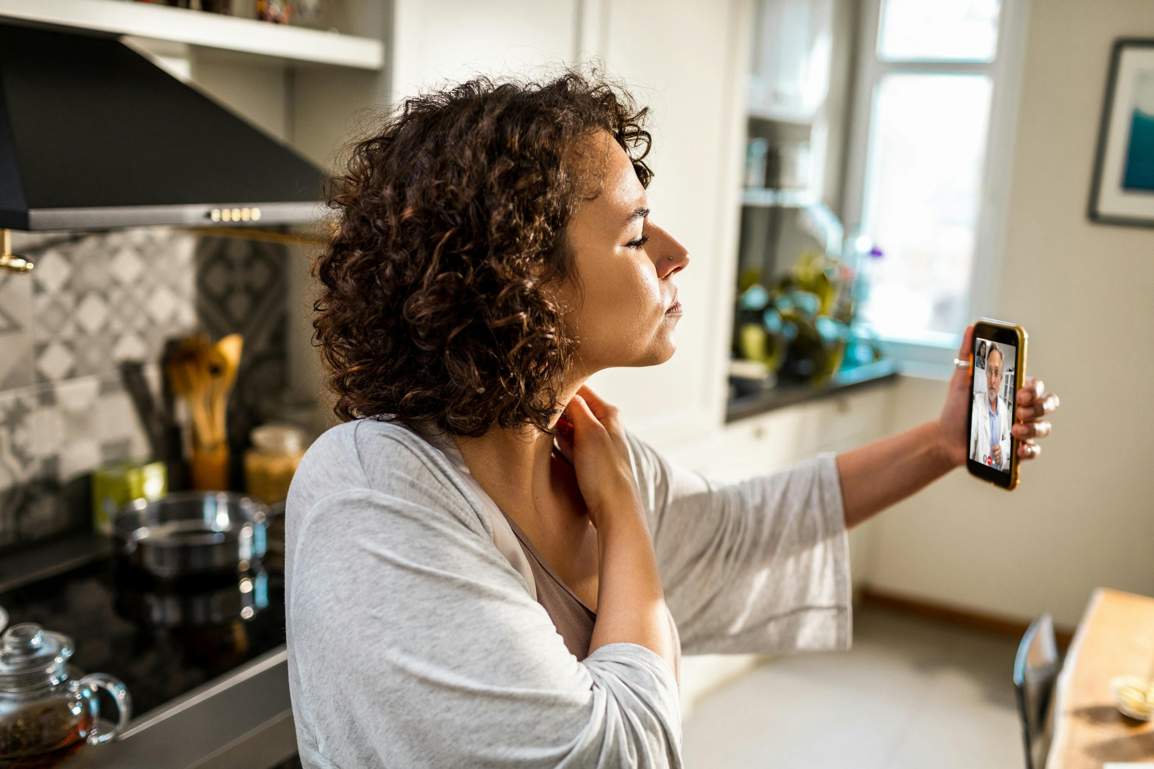 Young woman talking to her doctor on a video call