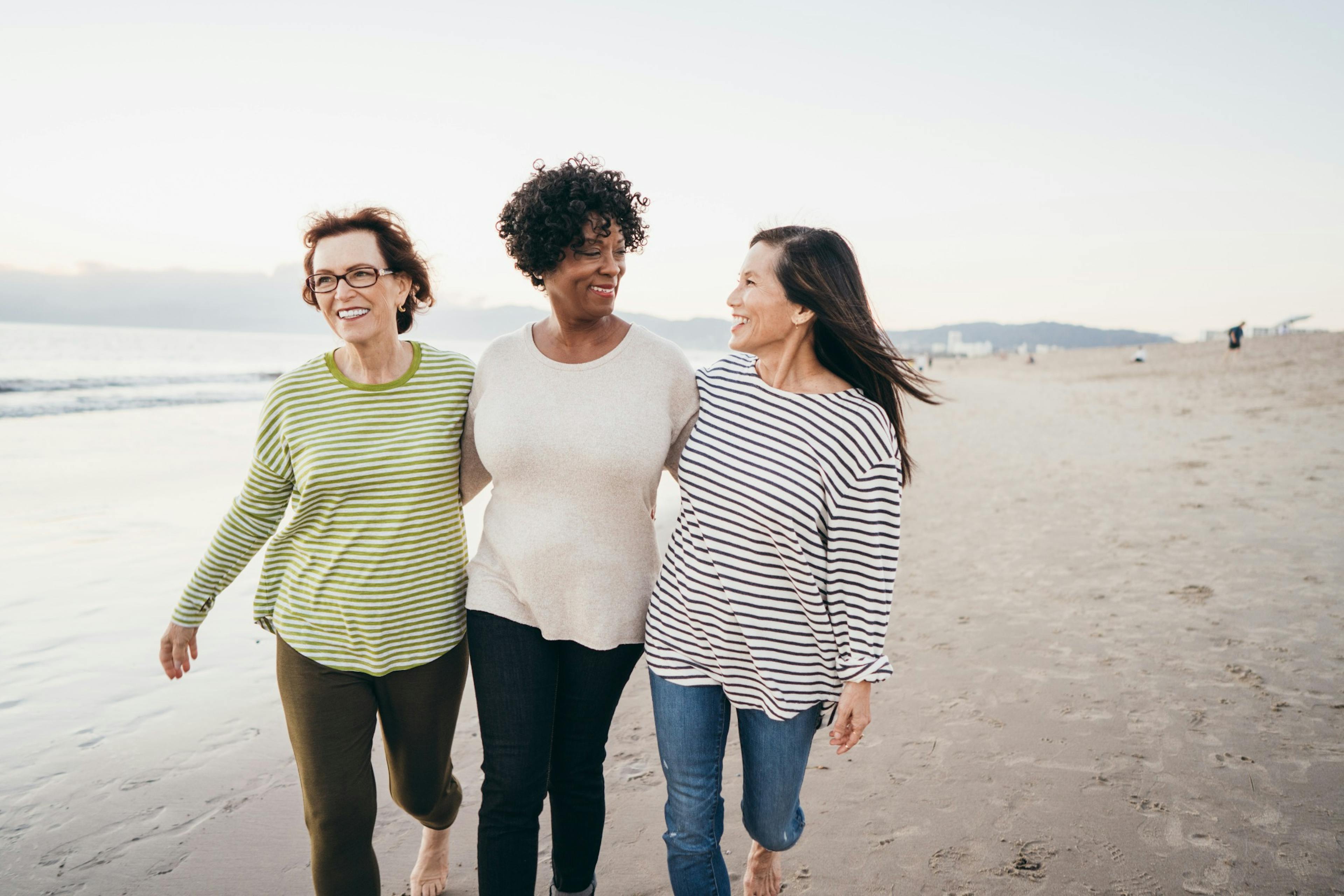 girlfriends walking down the beach