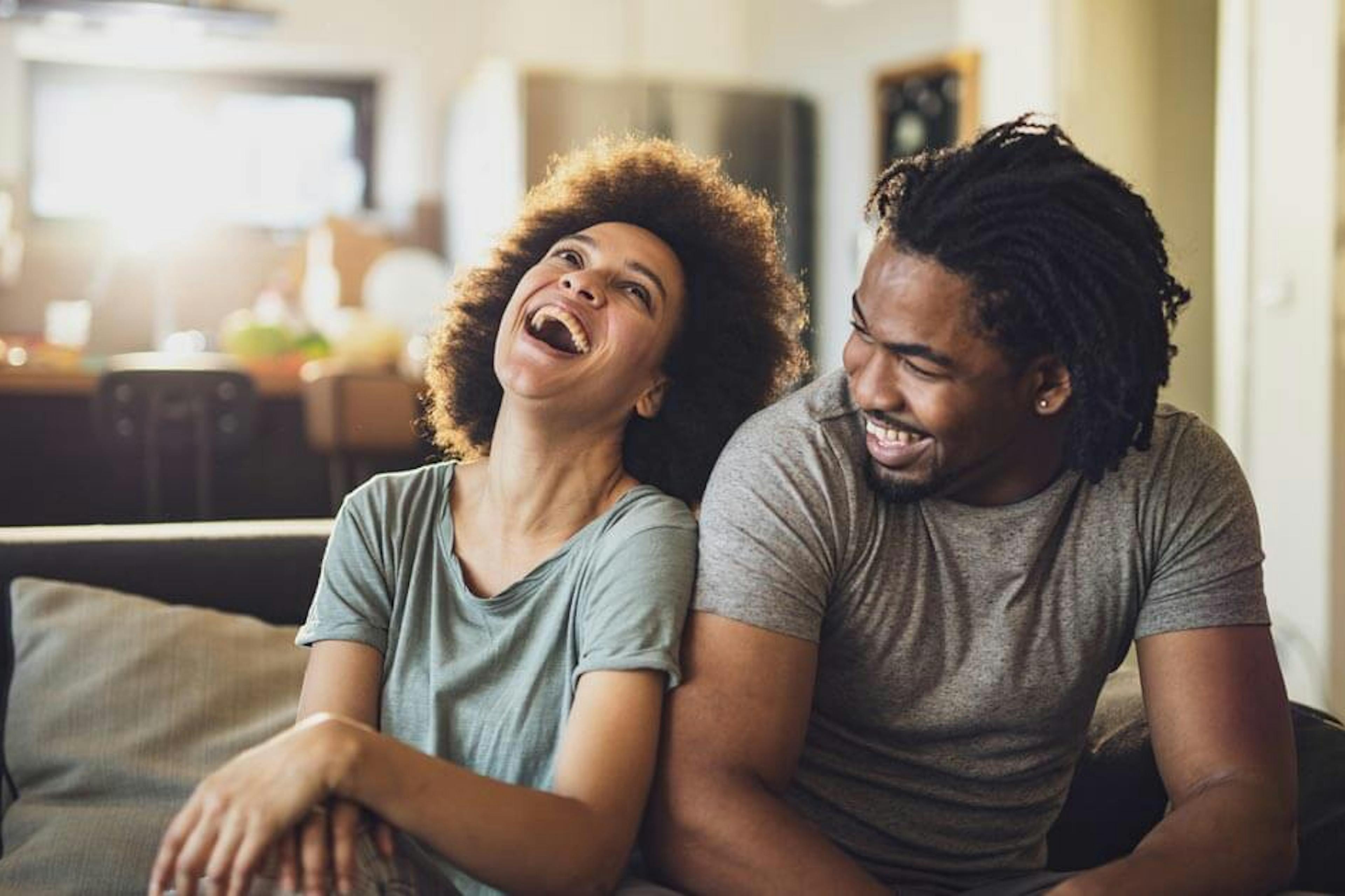 couple laughing on the couch