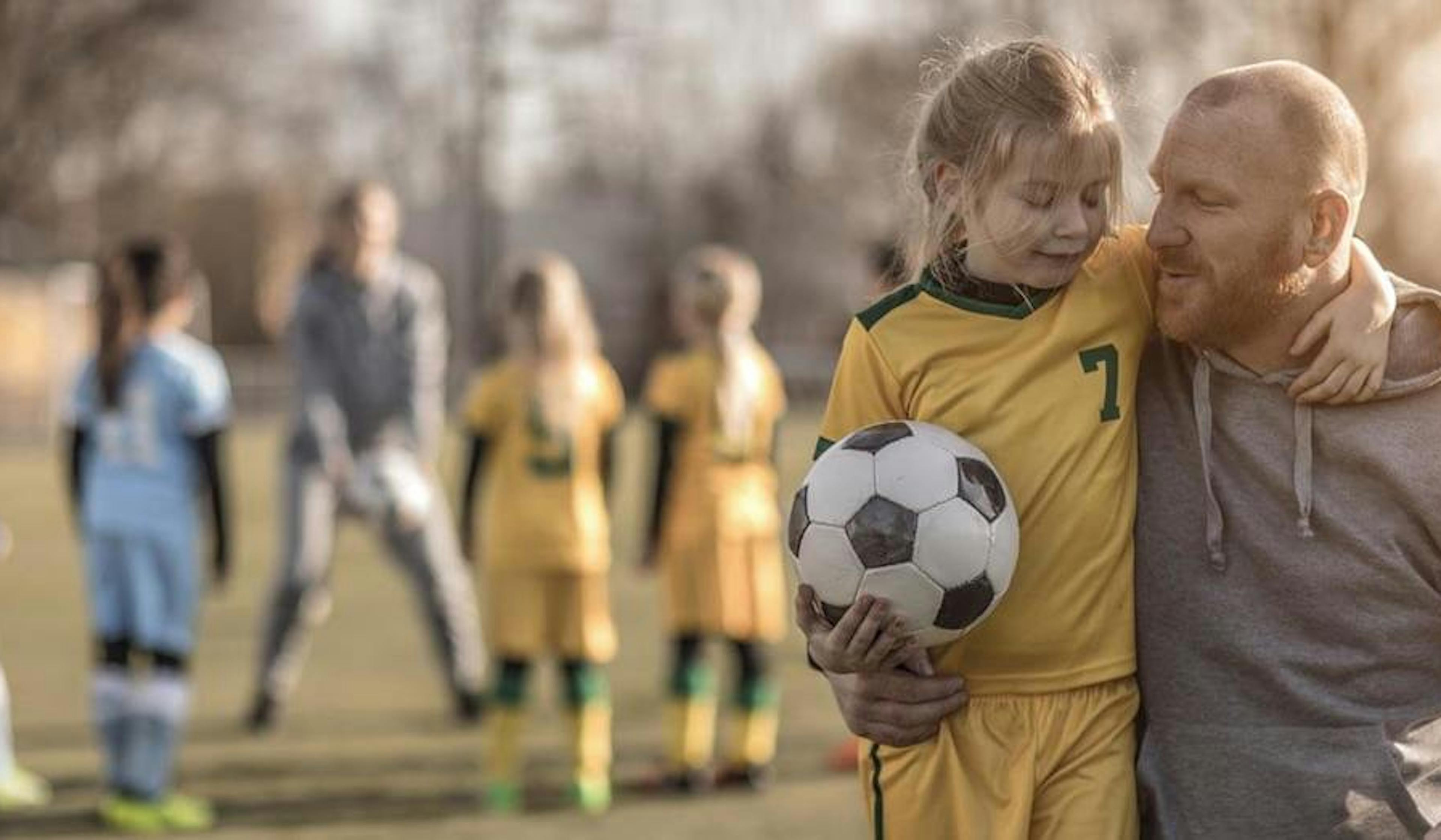 dad and daughter at soccer practice