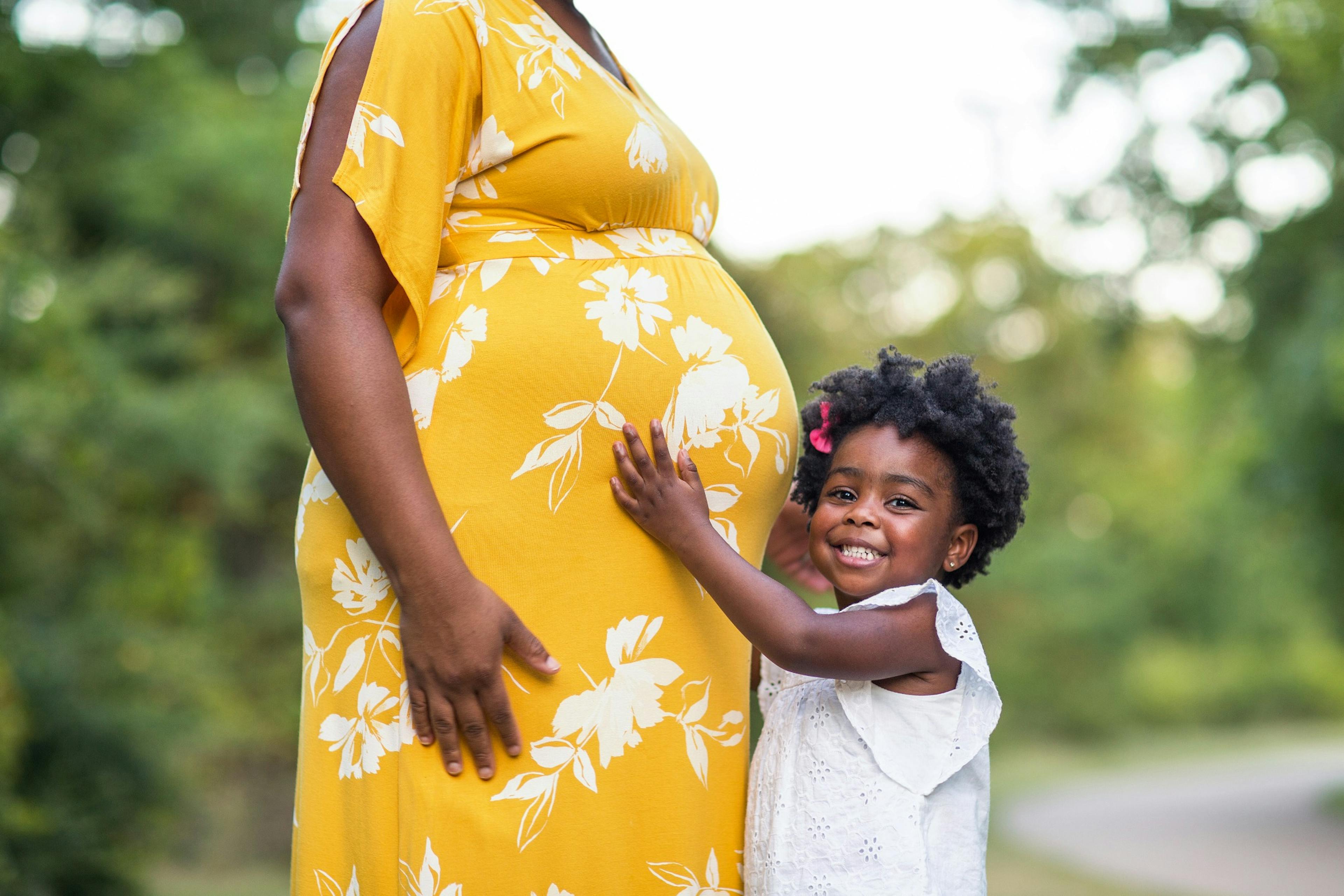 beautiful pregnant mom and daughter