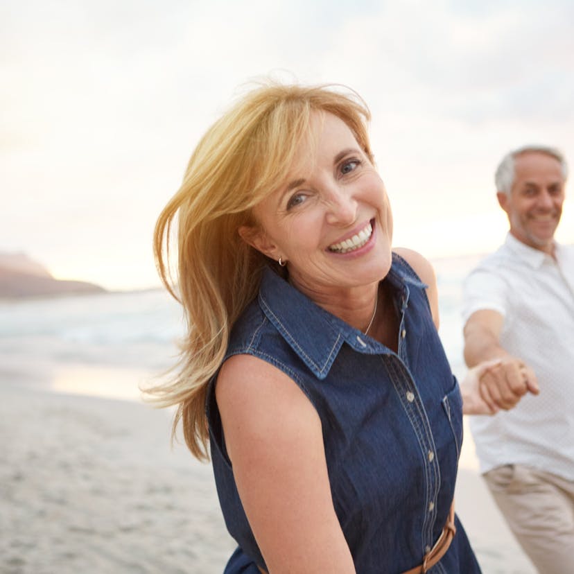 happy middle age couple on the beach